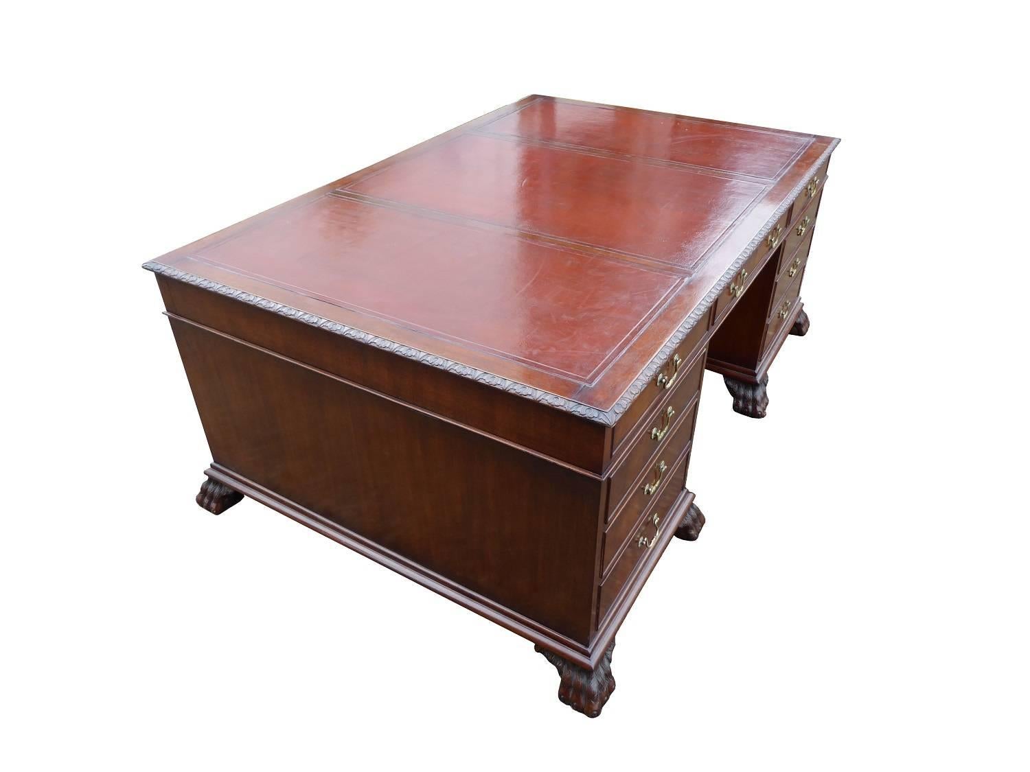 For sale is a good quality 20th century pedestal partners desk. The top of the desk has three very good quality leather hide inserts with tooling. The top also has three opposing drawers on each side. The top fits onto two pedestals, one side with