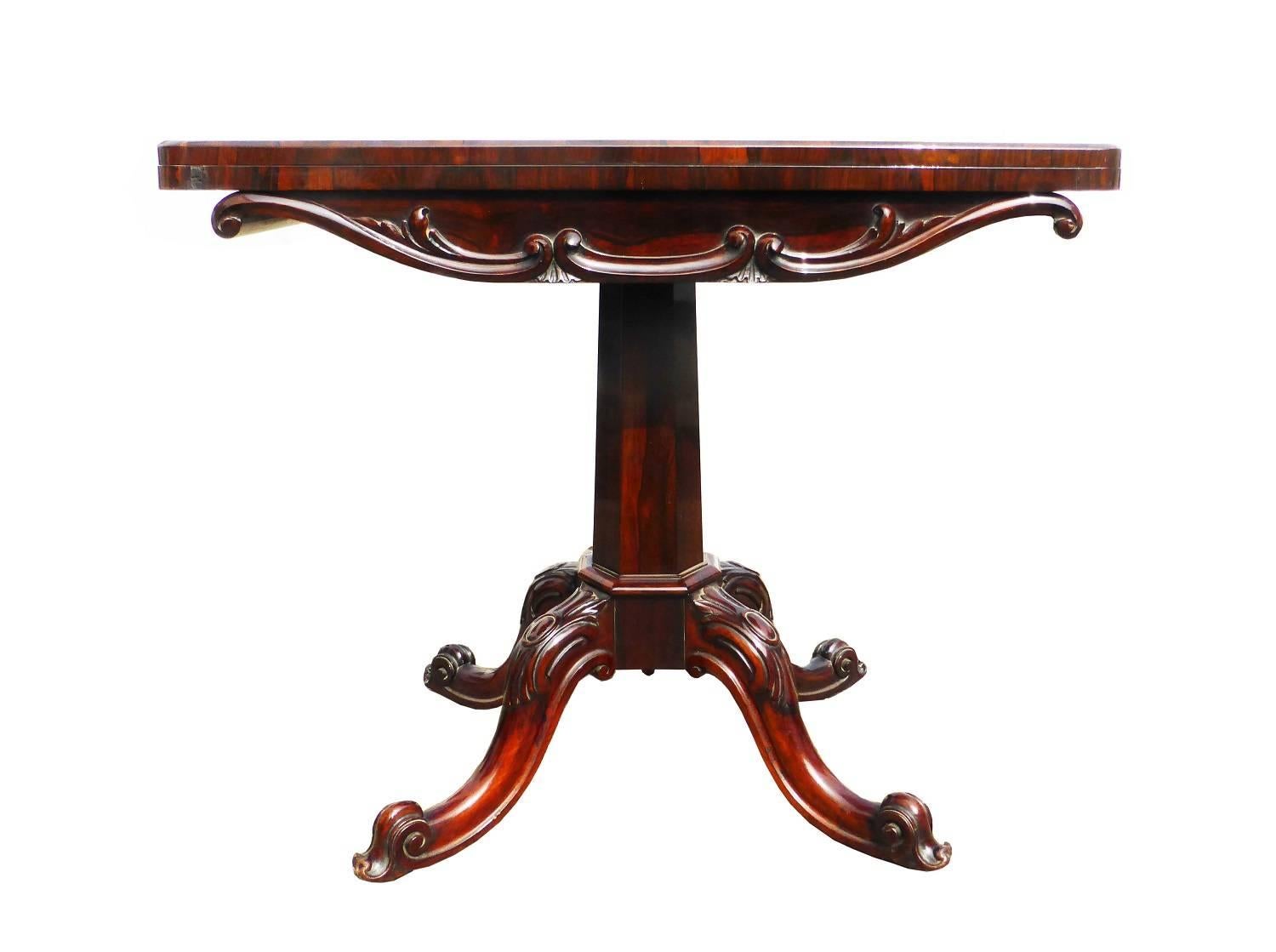 For sale is a Victorian rosewood card table. The top of the card table is decorated with floral carvings to the front. The top swivels and folds over to reveal a green baise, which is in excellent condition. The base of the table has four