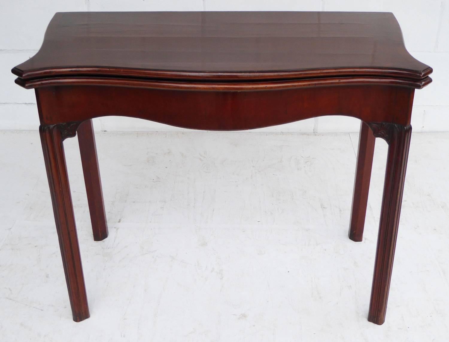 For sale is a good quality early George III mahogany serpentine cad table. The top of the table folds over to reveal a shaped green baise, above four square legs, with small fretwork brackets. This piece is in good condition for its age, with minor
