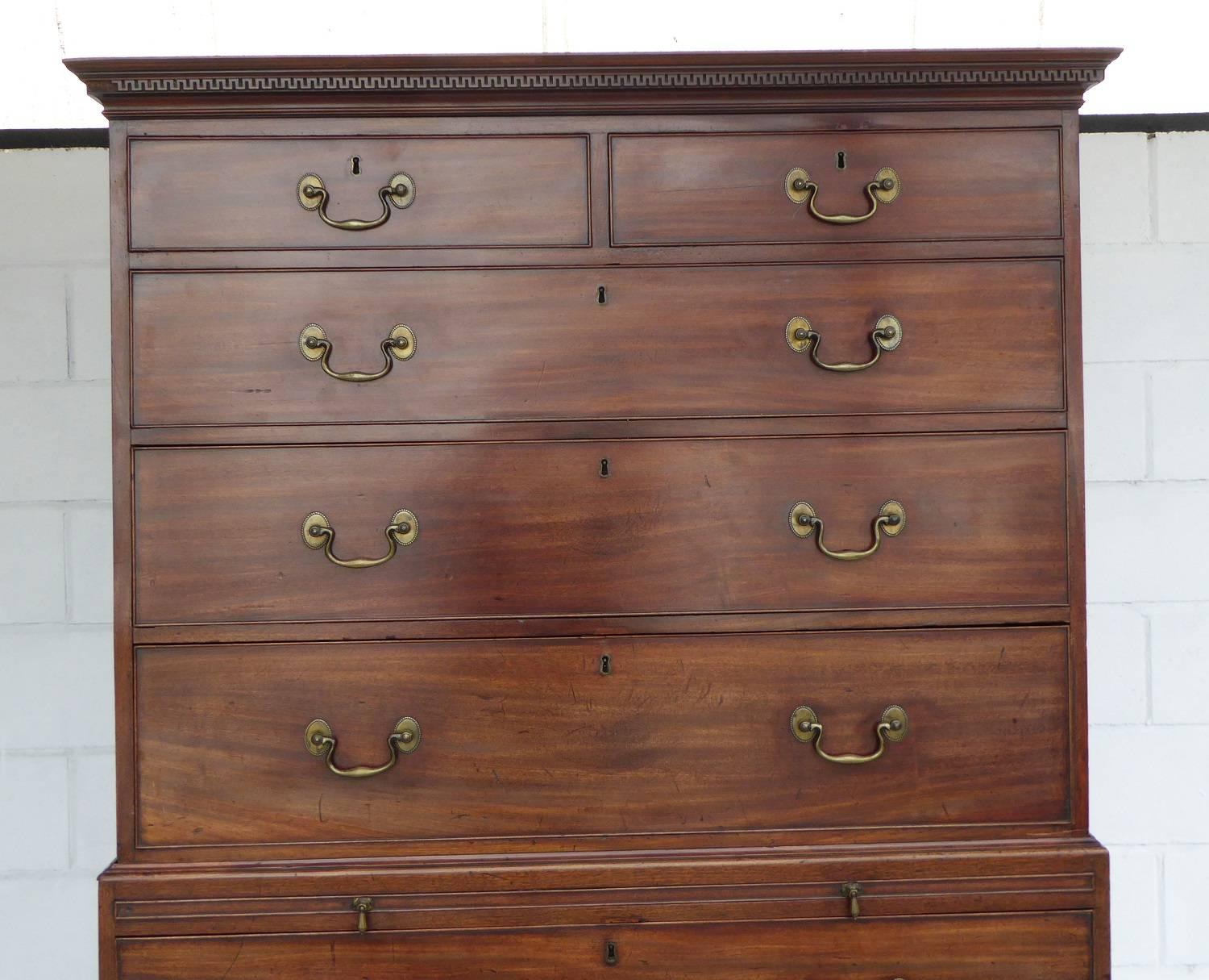 For sale is a good quality George III mahogany chest on chest. The top of the chest has an assortment of five drawers, having two short drawers and the top, with three graduated drawers below. This fits onto the base section, which is complete with