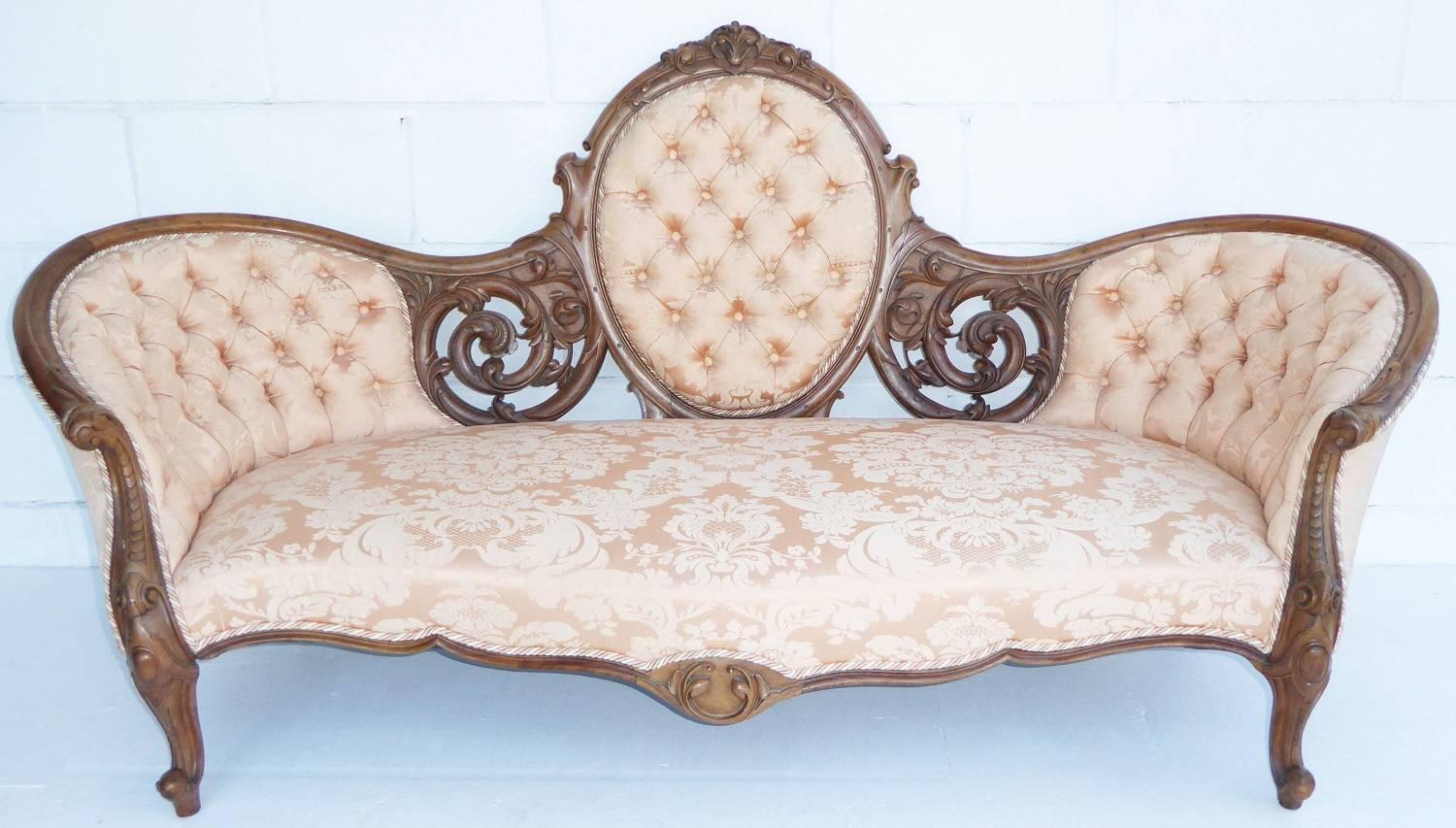 For sale is a fine quality Victorian walnut three-piece suite consisting of a sofa, a gentleman's armchair and a ladies armchair. The sofa has a cameo back, with ornate carvings either side, and all of the upholstery and fabric is in a nice, clean