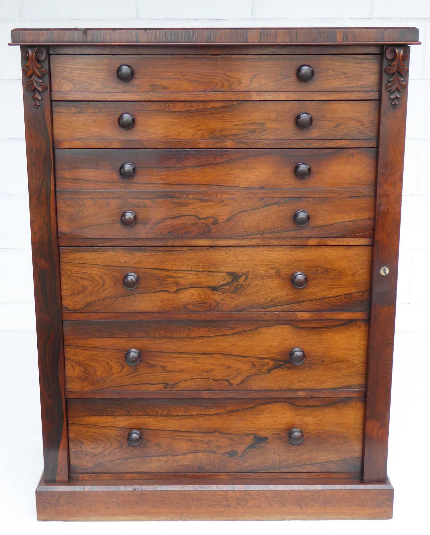 For sale is a very good quality Victorian rosewood secretaire Wellington chest. The chest has six graduated drawers, each with turned handles. The third drawer down is a secretaire, with a fall front opening to reveal a fitted interior comprising