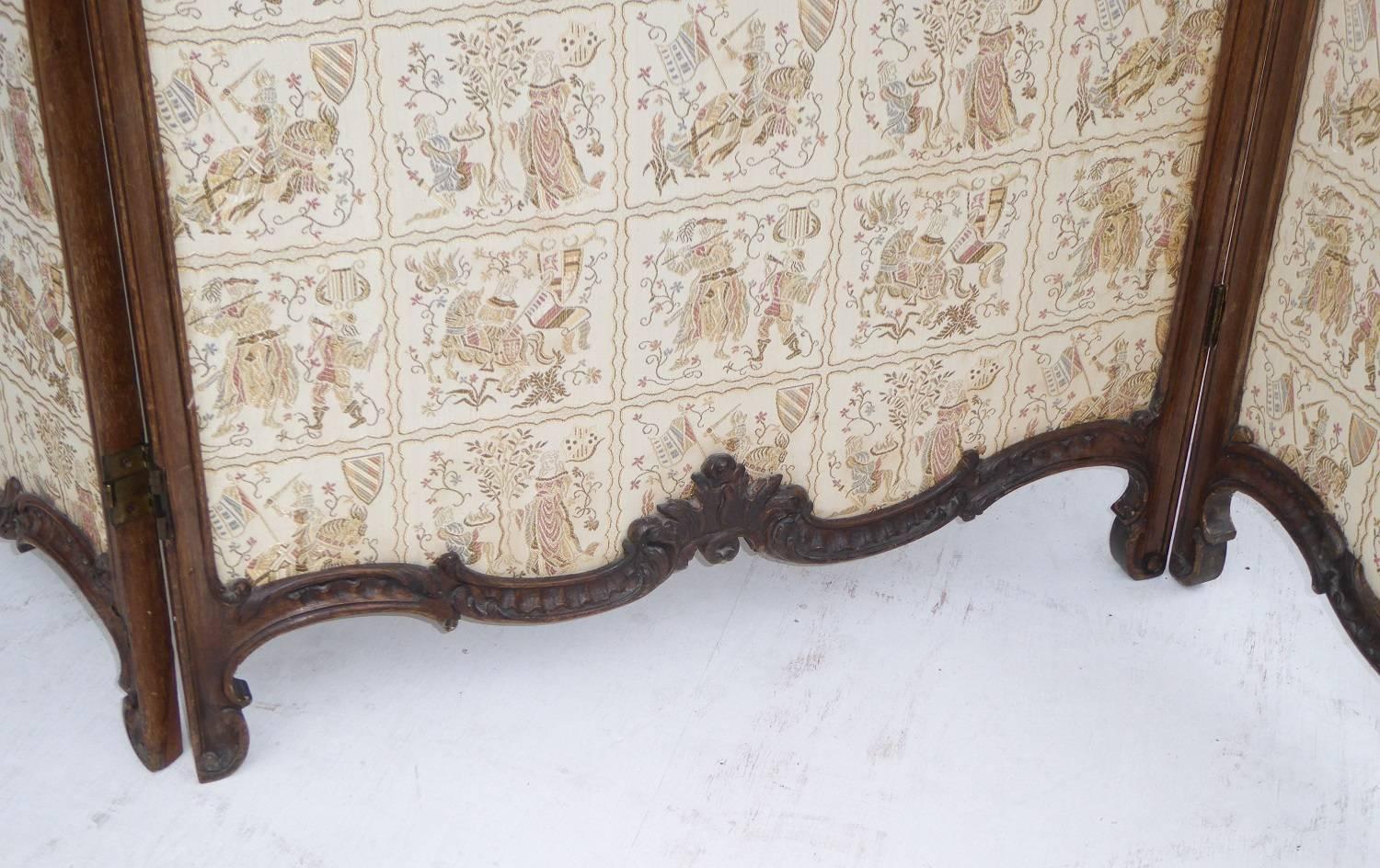 For sale is a good quality 19th century French dressing screen. The screen is ornately shaped and carved at the top, above three glass panels with further carving below. Under this the screen is upholstered and stands on shaped feet. Overall, this