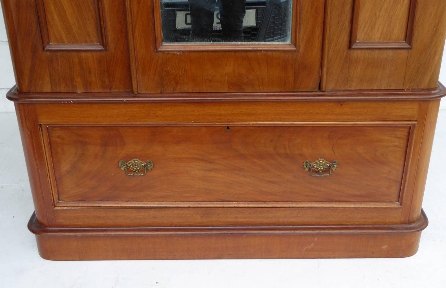 For sale is a good quality Victorian burr walnut wardrobe. The wardrobe has an out swept cornice to the top, above a single mirror door, flanked by a further two mirrors. The centre door opens to reveal two hanging rails as well as coat pegs. Below