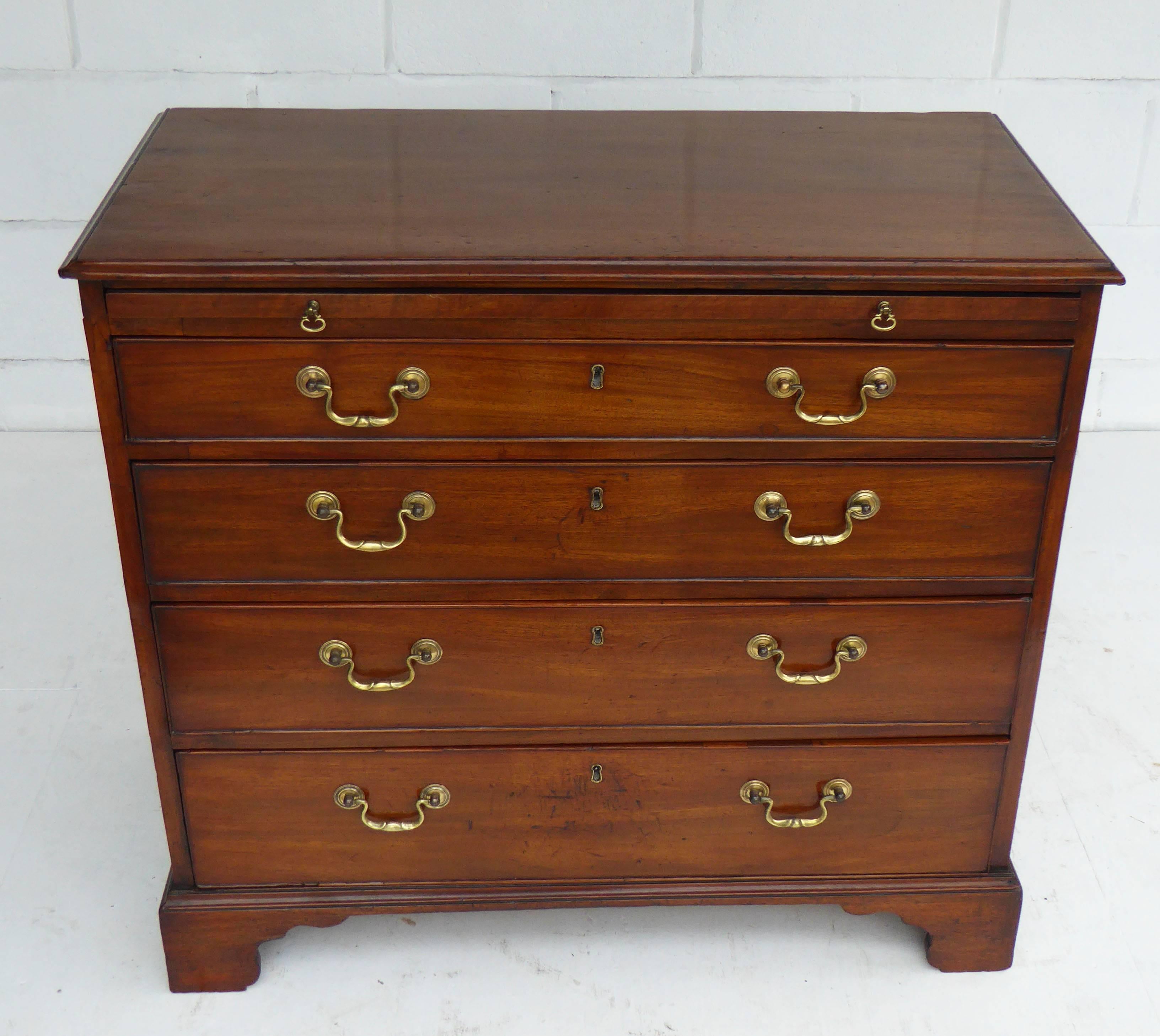 For sale is a good quality George III mahogany chest of drawers with brushing slide. The chest has an assortment of four graduated drawers, each with brass swan neck handles. The chest stands on bracket feet and is in very good condition having been