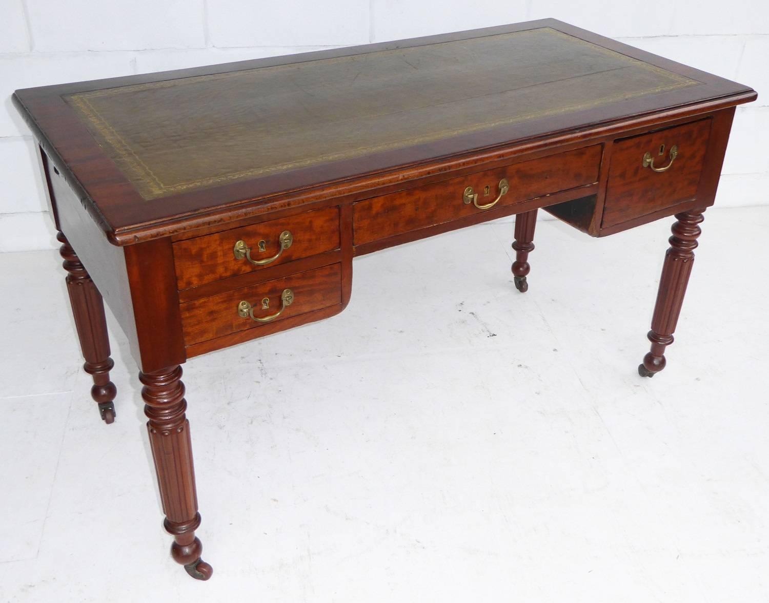 For sale is a good quality William IV mahogany writing table. The top of the writing table has a green leather insert, with decorative tooling. The top also has a pull-out slide on either side, revealing a further leather writing surface. The desk