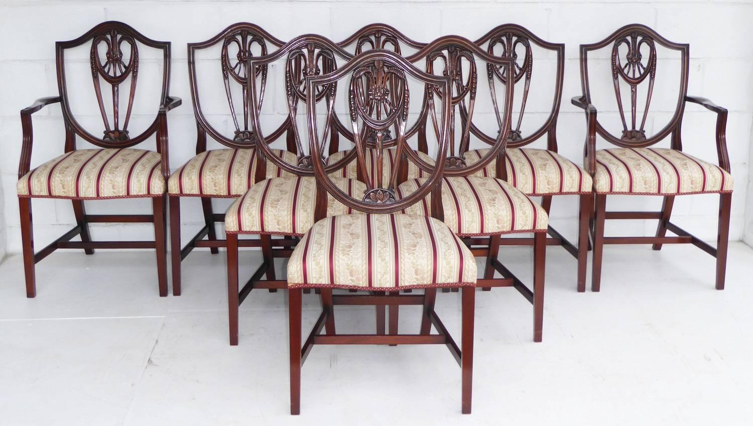 For sale is a top quality Regency style mahogany pedestal dining table and eight chairs by Bevan and Funnell, a top English cabinet maker. The table has two additional leaves allowing the table to seat eight comfortably. The chairs have a shield