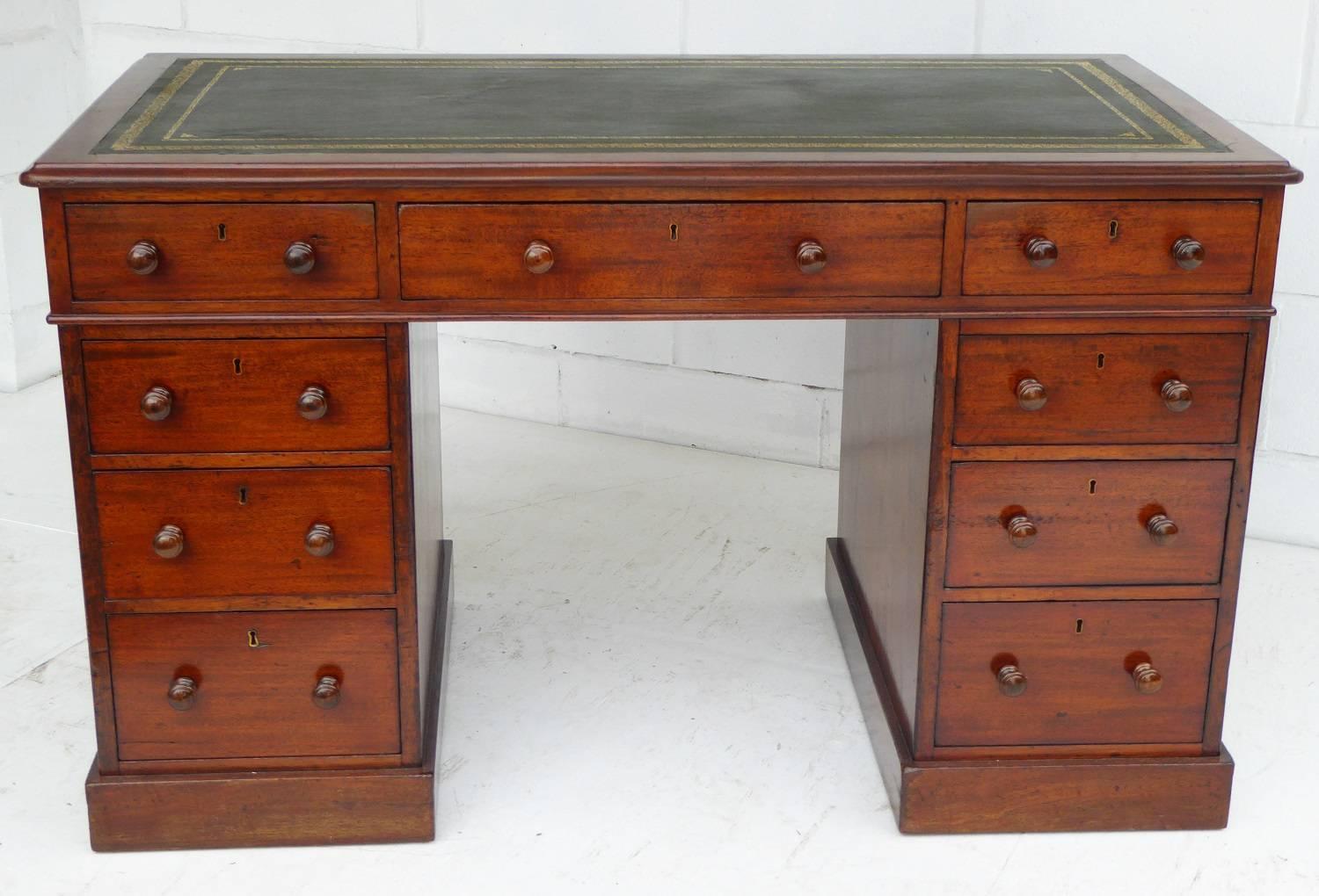 For sale is a fine quality Victorian solid mahogany pedestal desk by Holland & Sons. The top of the desk has a green leather hide insert, with decorative gold tooling. Below this there are three drawers, the centre of which being stamped 