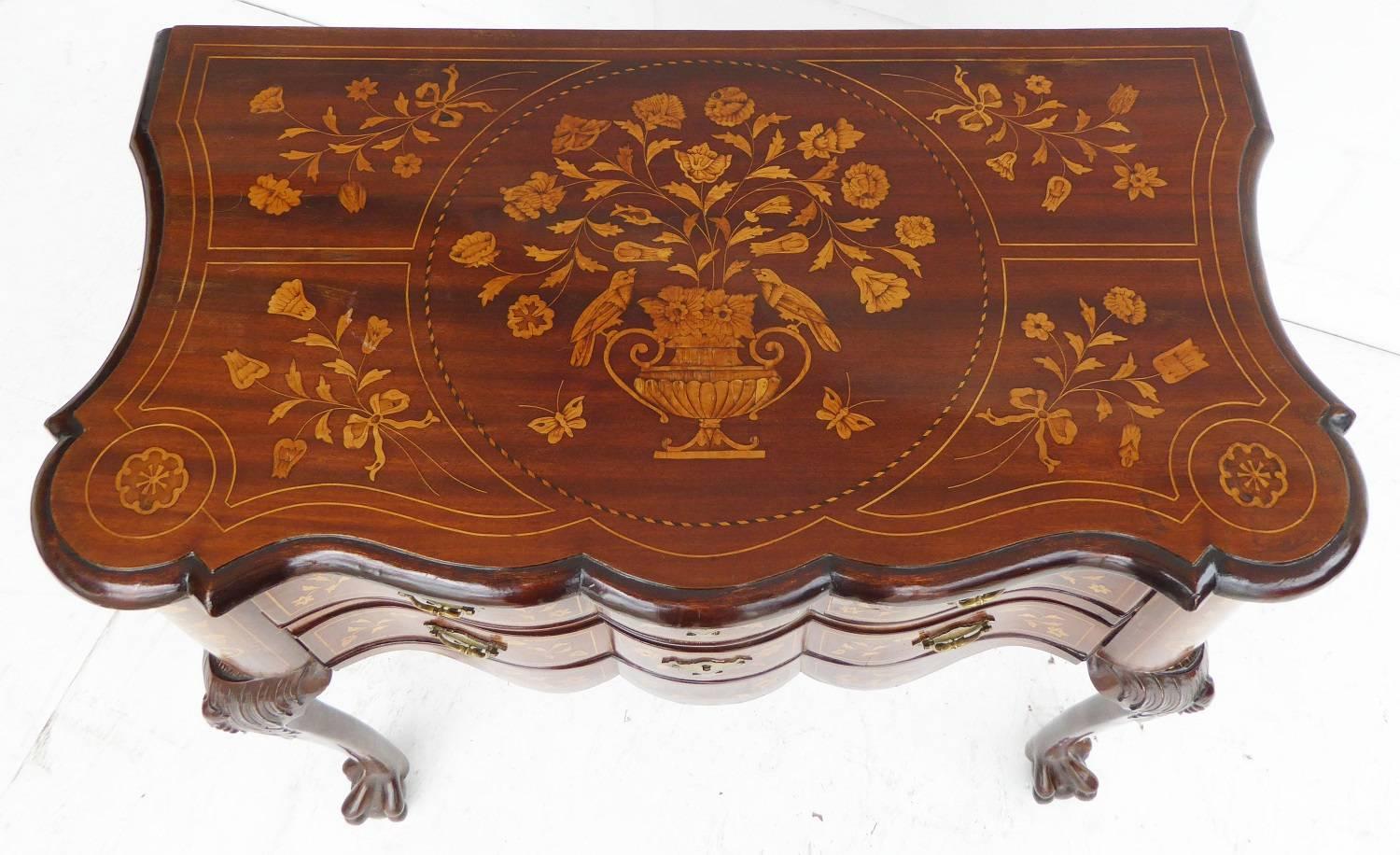 For sale is a 19th century Dutch marquetry chest. The chest has an ornately inlaid top above two serpentine drawers, all with matching marquetry inlays. The chest stands on carved cabriole legs terminating on claw and ball feet. This piece is in