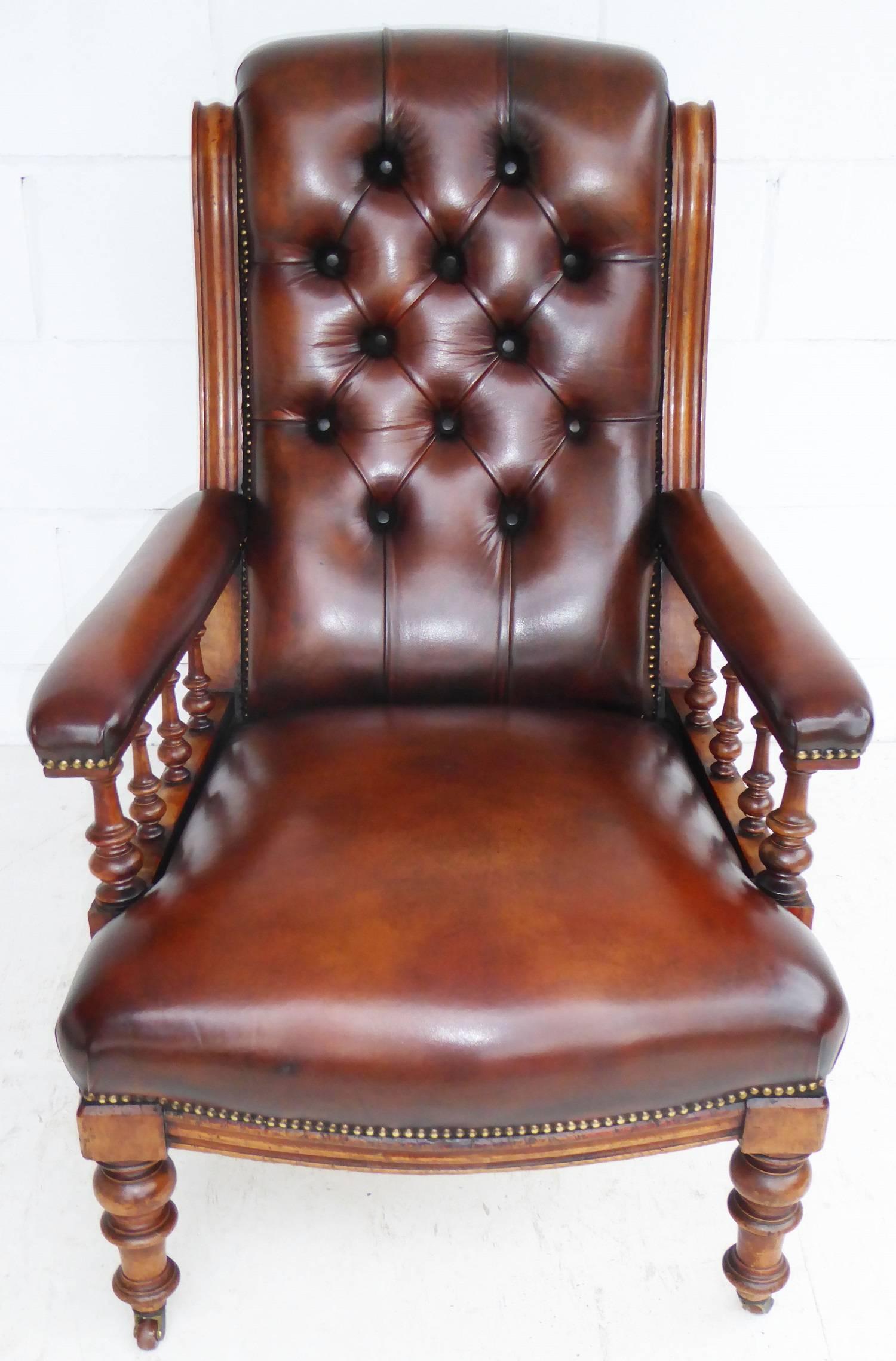 For sale is a good quality 19th century Mahogany Library chair upholstered in hand dyed tan leather. The chair has a beautifully scrolled and buttoned back, with small turned supports under each arm. Both arms are also upholstered. the chair stands
