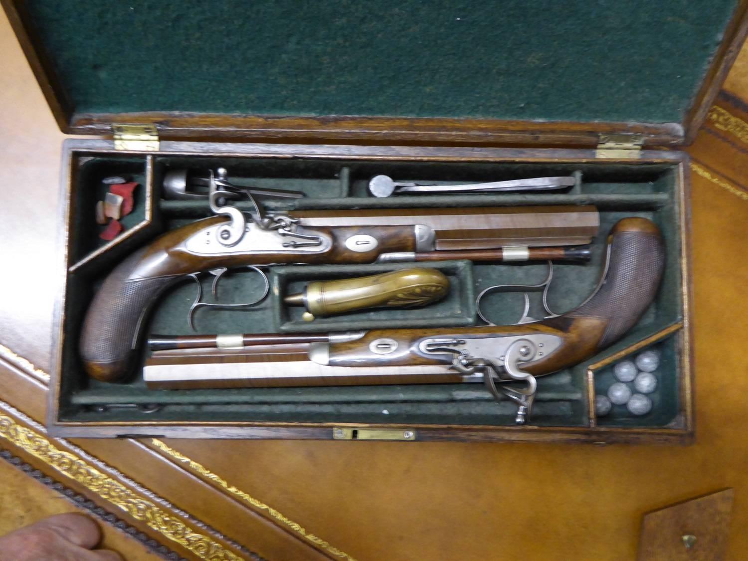 For sale is a Classic pair of 16 bore flintlock dueling pistols, circa 1820, in first class condition in their green baize lined travelling case. Complete with accessories, I.E lead balls, powder flask, horn tipped ramrods, wadding cutter, flints