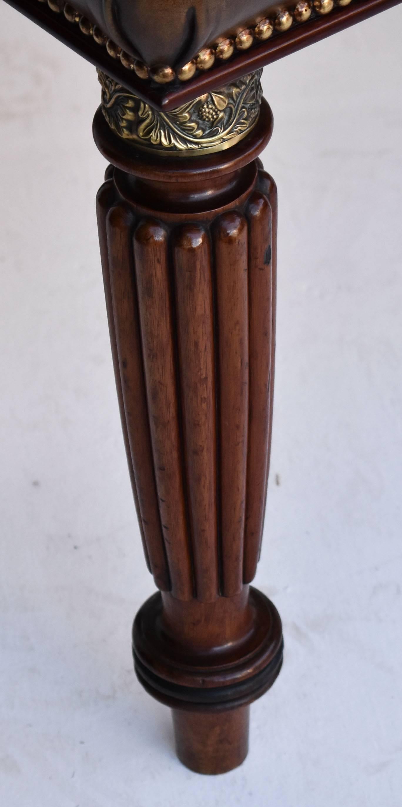 For sale is a top quality 19th century mahogany stool. With six turned and fluted legs, each with ornate brass surrounds to the top. This is below a deep buttoned leather seat. The legs, the frame and the upholstery of the stool are in an excellent,