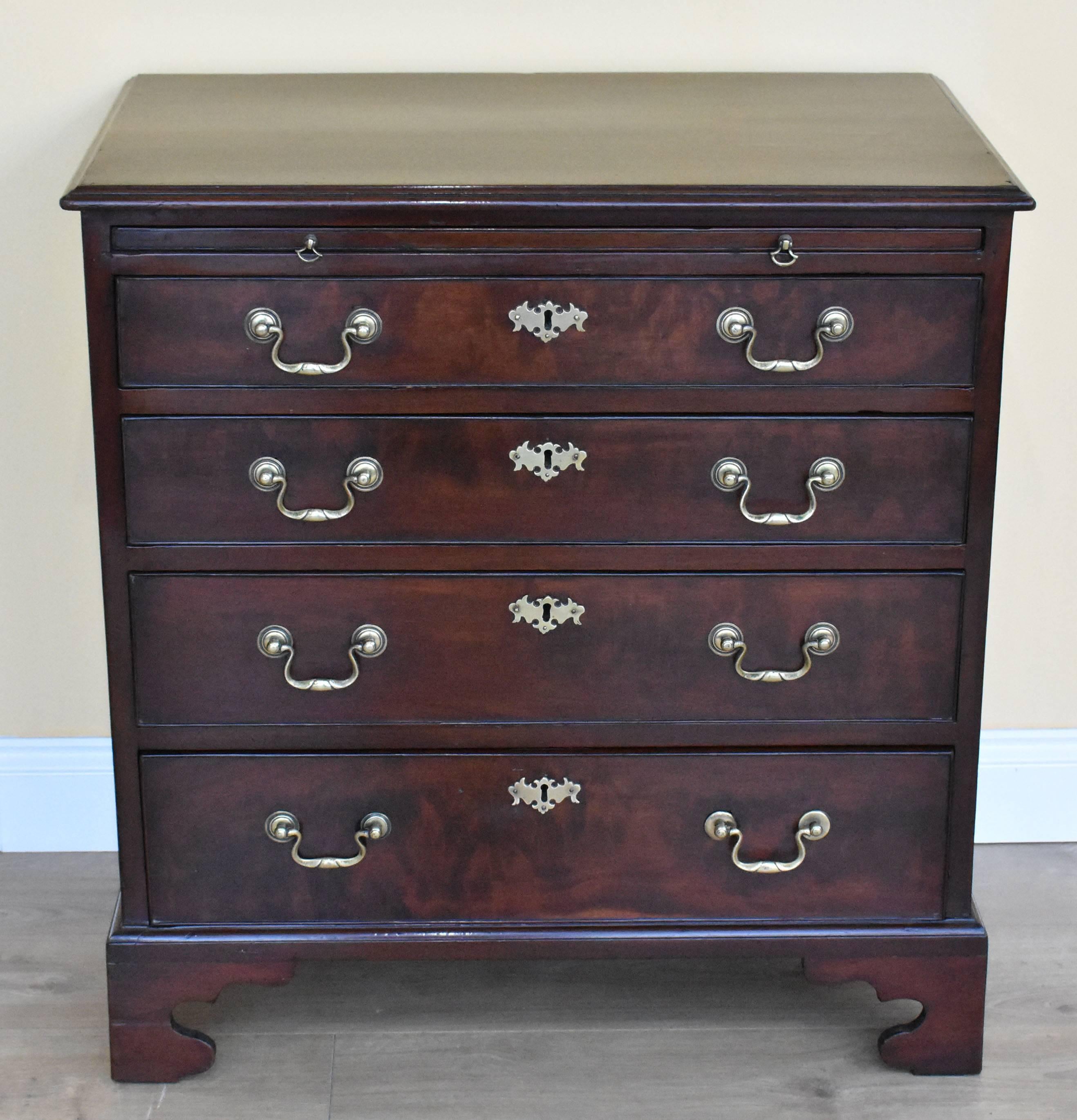 For sale is a good quality George III Mahogany Chest of Drawers of Small Proportions. The chest has a brushing slide to the top, above four graduated drawers, each with brass handles and escutcheons. The chest stands on bracket feet and is in