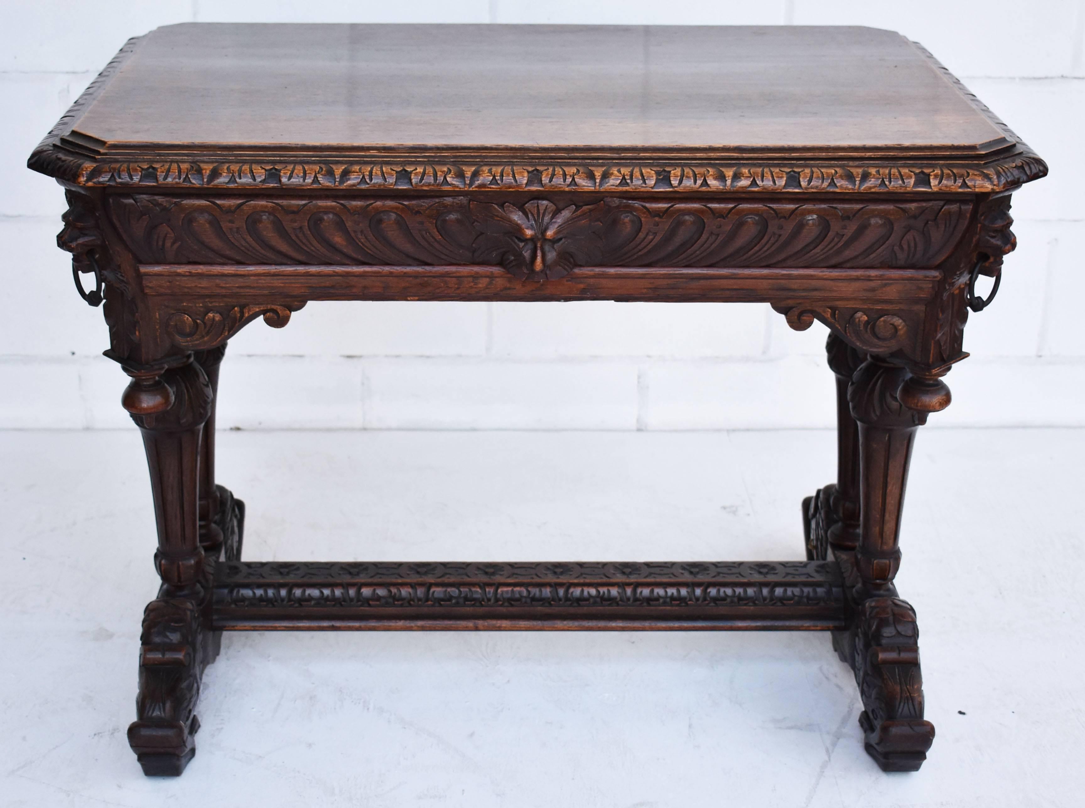 For sale is a good quality Victorian solid oak carved centre table. The table has intricately carved lion masks on each corner, with ornate carvings on each frieze, above shaped and carved legs united by a central carved stretcher, standing on