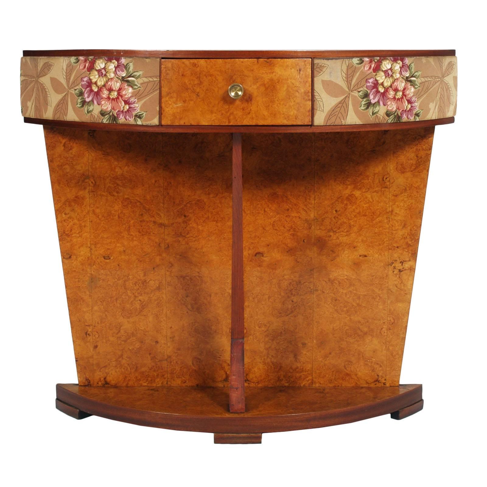 

1930s Mid Century Italian Art Deco Mirrored Console in Elm Briar Gio Ponti style. Half-moon top with drawer, with apron decorated with floral motifs with characteristic plasticised fabric of the time.
Elegant Midcentury piece , Gio Ponti manner