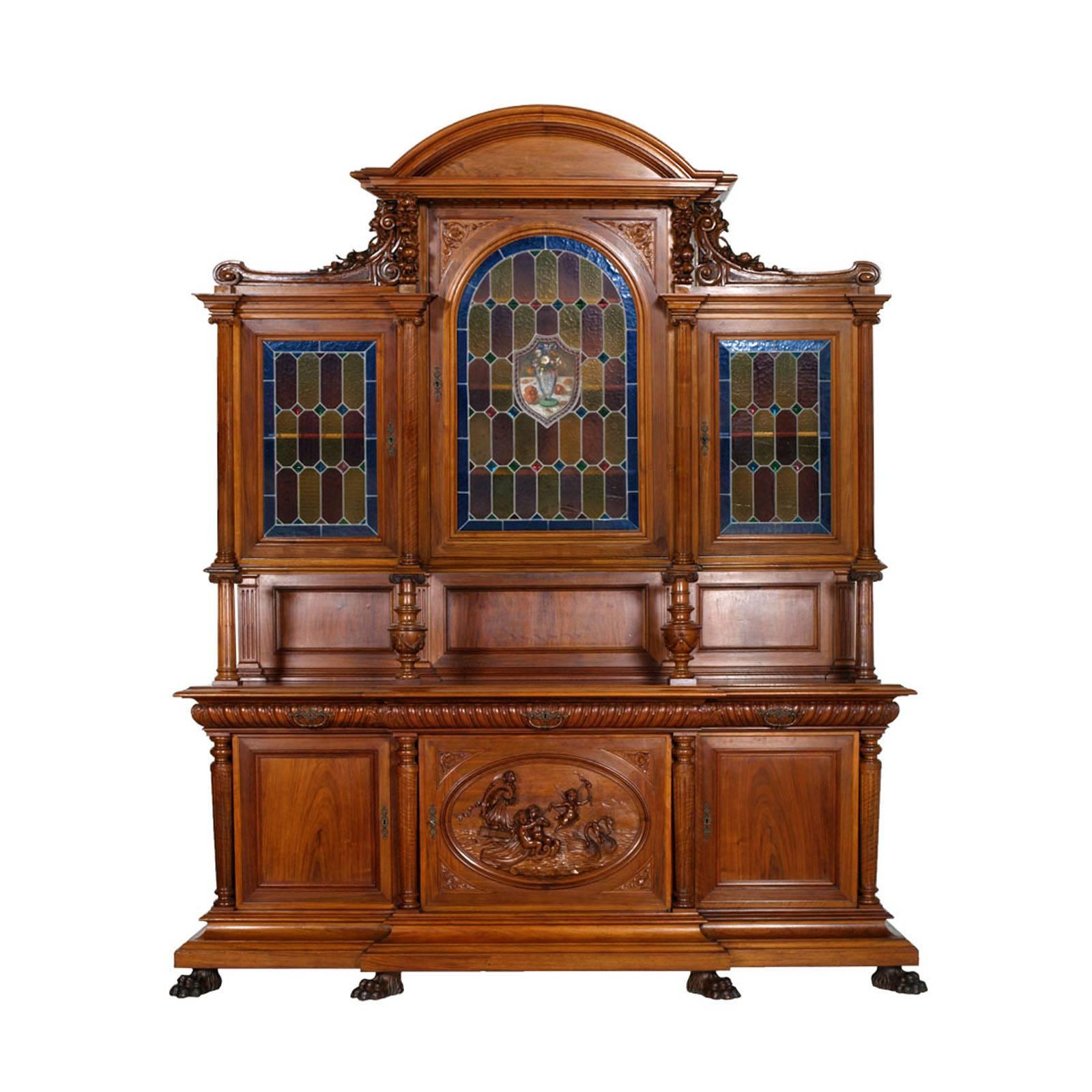 Code: FQ58
Period: 19th century 
Style: Renaissance 
Dining room of the School of Arts in Monza, 19th century, walnut hand-carved consists of:
sideboard showcase with leaded cathedral glass; 
sideboard with central mirror; 
console with large