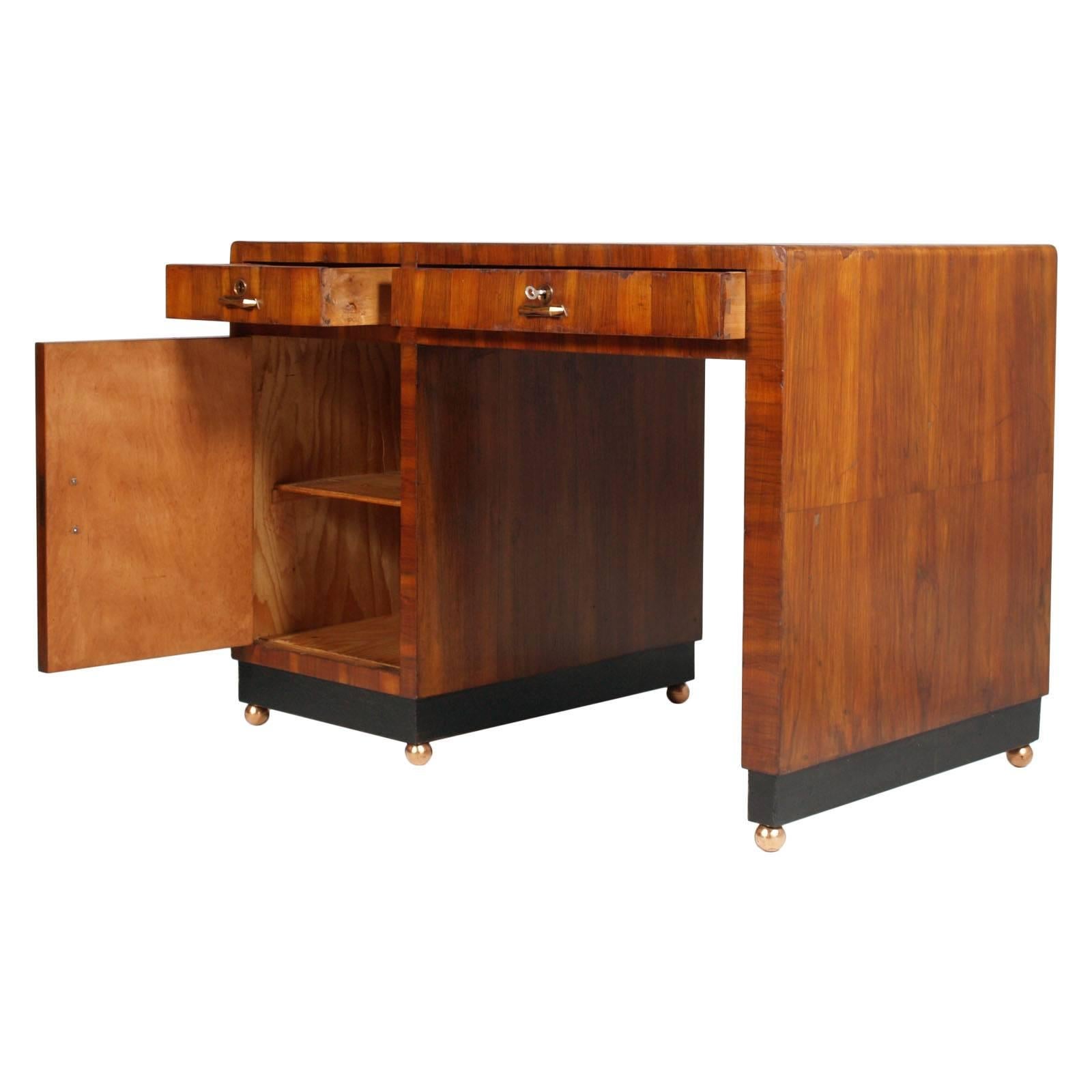Italian 1930s very elegant Art Deco Desk by Osvaldo Borsani, thick walnut veneer , lower band ebonized with copper-plated ball feet, wax polished

Measure in cm :D70 W115 H85.