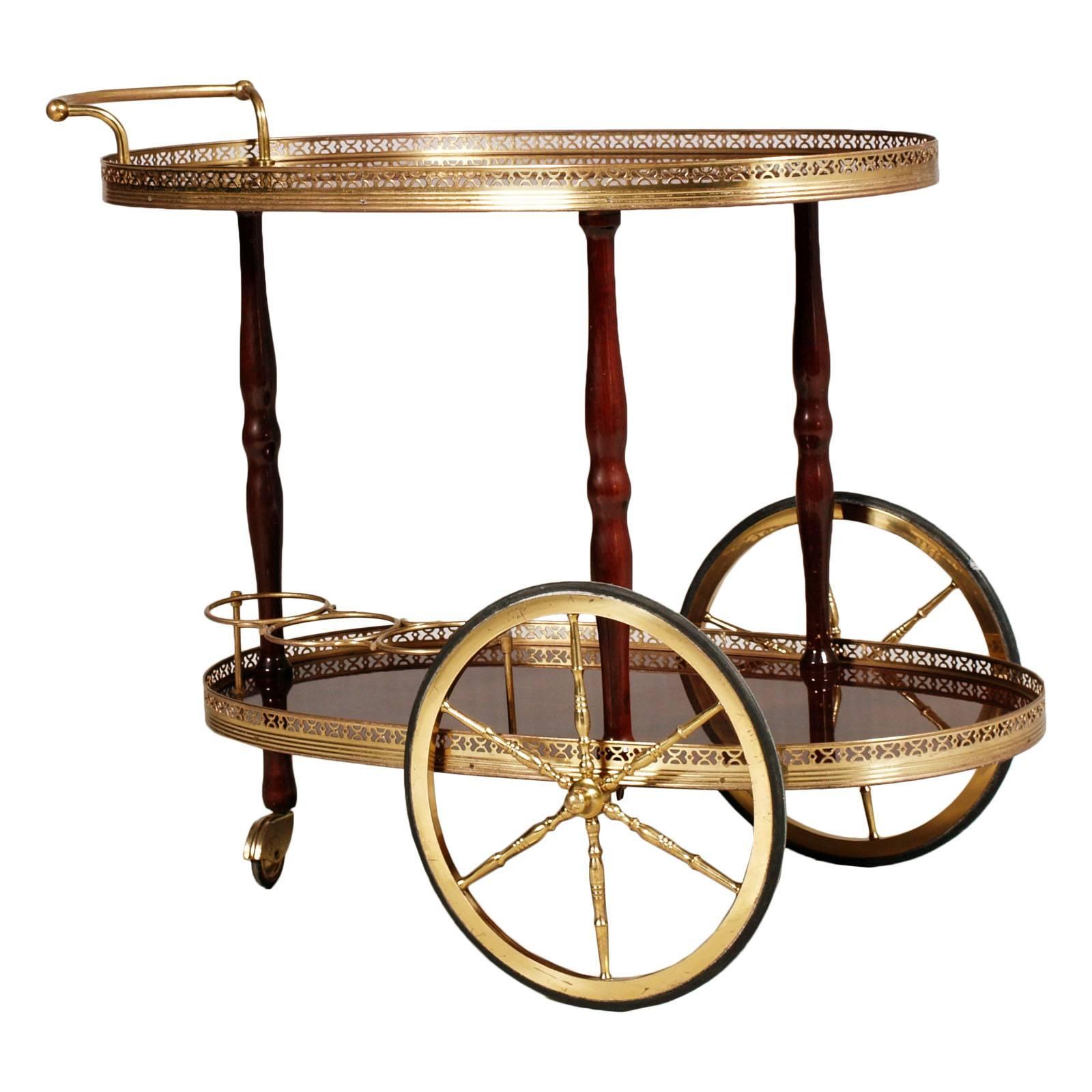 Refined Italian Belle Époque bar cart gilt brass tops in mahogany vetrified, period 1910s -1920s

Measure in cm: H 68, W 80, D 45.