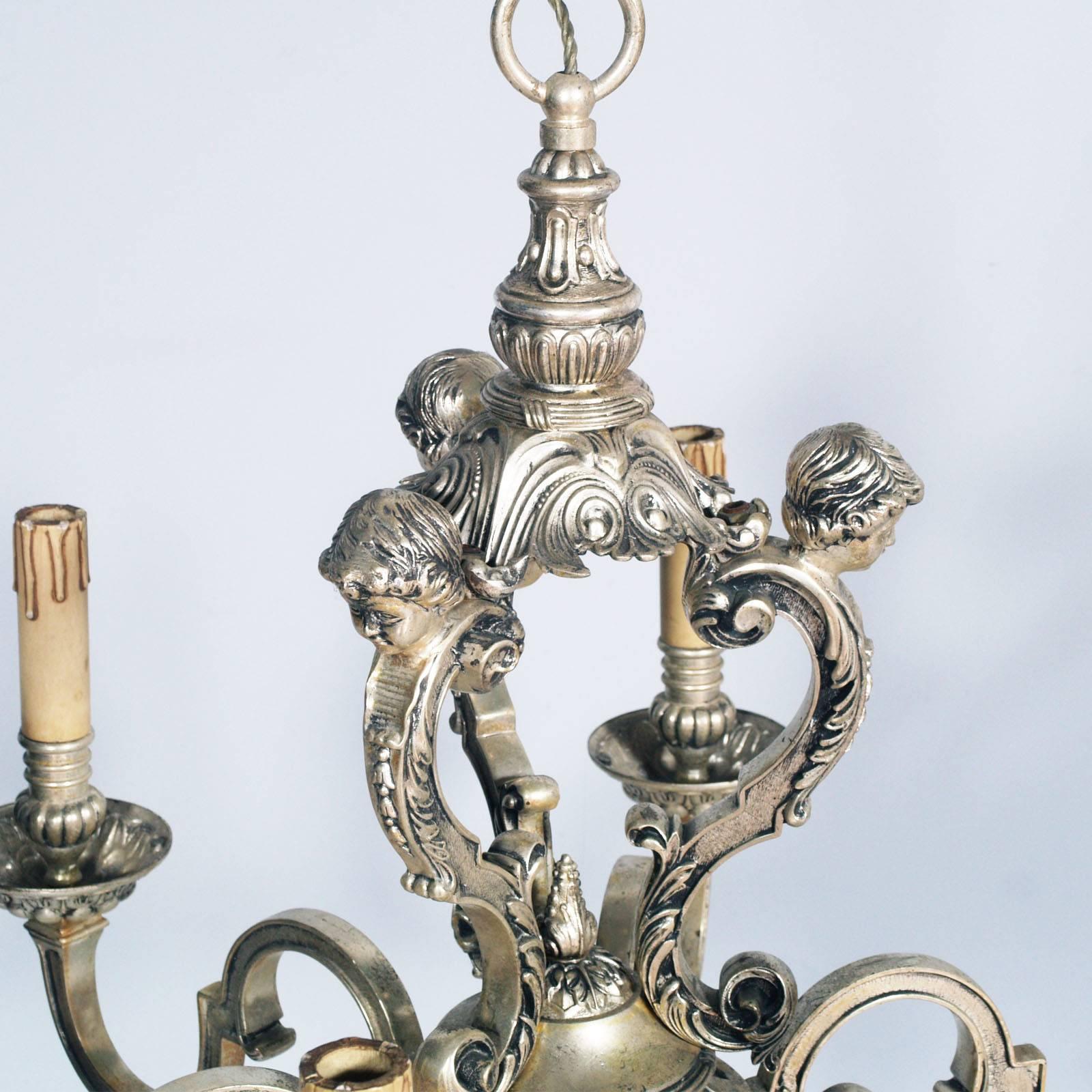 Antique French six lights chandelier exceptionally fine and large, silver plated bronze chandelier. The upper section with putti over strongly scrolled arm supports, elaborately cast and chiseled with decoration. Original plated silver and