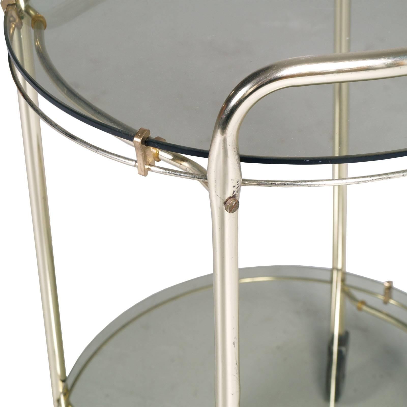 Italian elegant Mid-Century Modern bar cart in brass and smoked crystal 

Measures cm: H63 diameter. 45 (H internal shelf 40 cm).