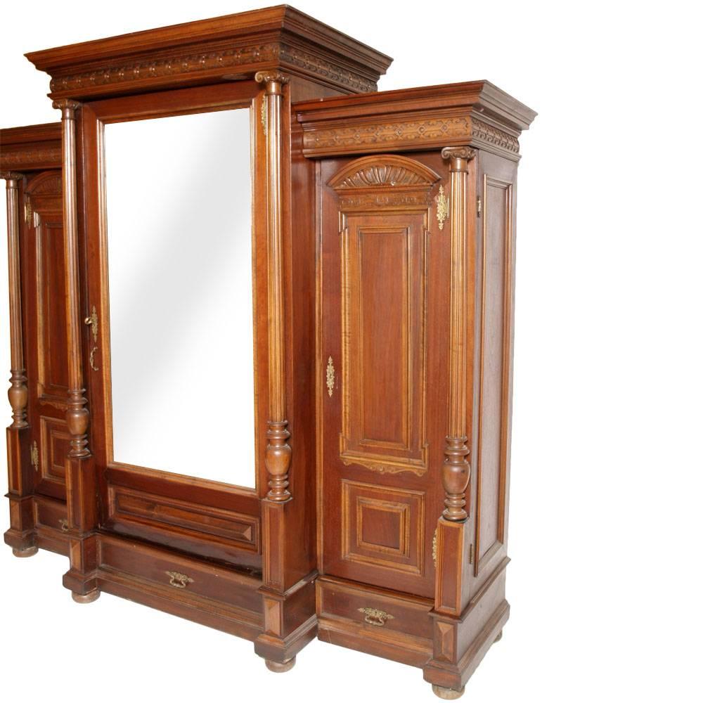 Importante armadio guardaroba neoclassico antico in noce massiccio intagliato a mano con specchio e cassetti. Restaurato e lucidato a cera

Misure cm: H. 222, L. 236, P. 80.