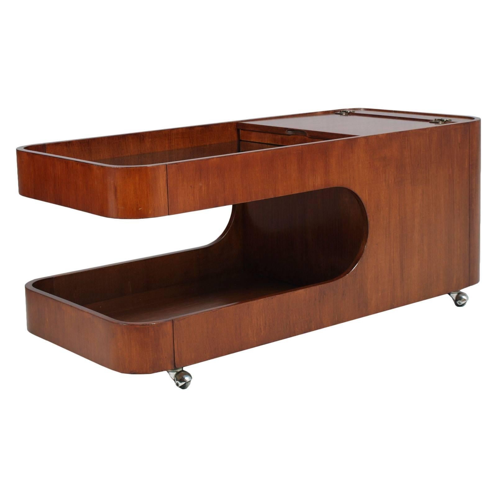 Italian Mid-Century Modern trolley coffee table, dry bar cart, magazine rack, Afra e Tobia Scarpa attributable. In mahogany and walnut,  polished to wax. A furniture high-design multi function.

Measures cm: H 47, W 110, D 50 (H37 \29 internal).