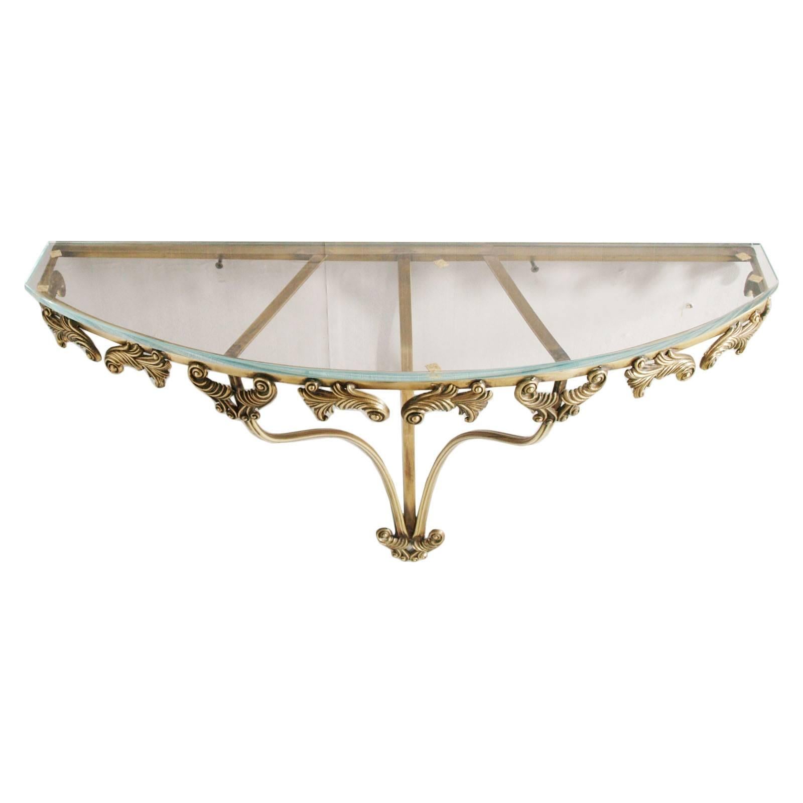 Mid-Century Modern console or nightstand in gilt bronze and brass, cristal, attributed to Colli, Torino, circa 1940's.
Measures cm: H 47, W 66, D 22.


About Pier Luigi Colli : History
The company was founded in Turin in 1850, as a workshop that