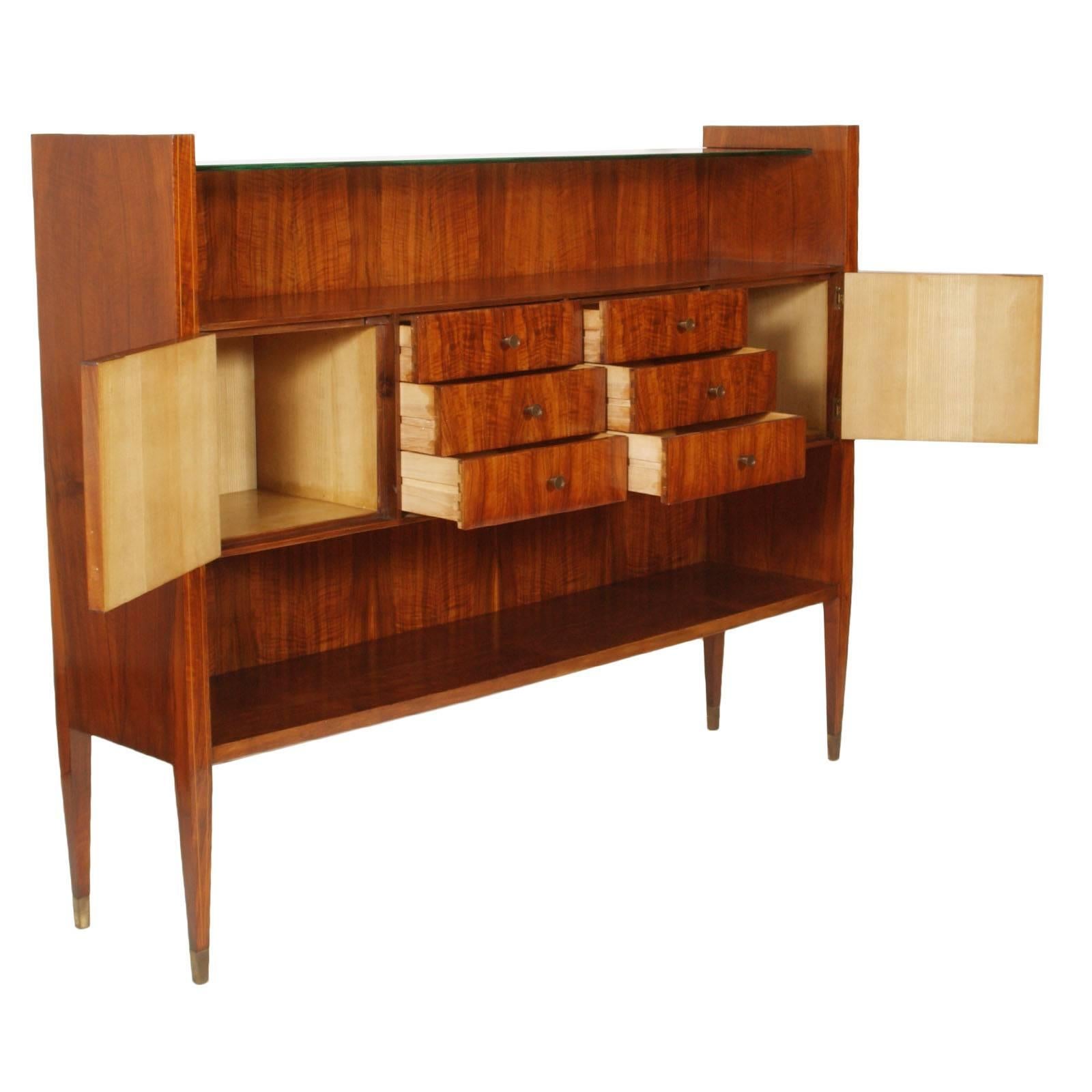 Midcentury Italian Rationalist credenza, external in rosewood with inlaid maple and interior in light wood maple. Crystal top shelf and brushed brass accessories. In excellent conditions.
Very modern and timeless sideboard

Measures cm: H 140 x W