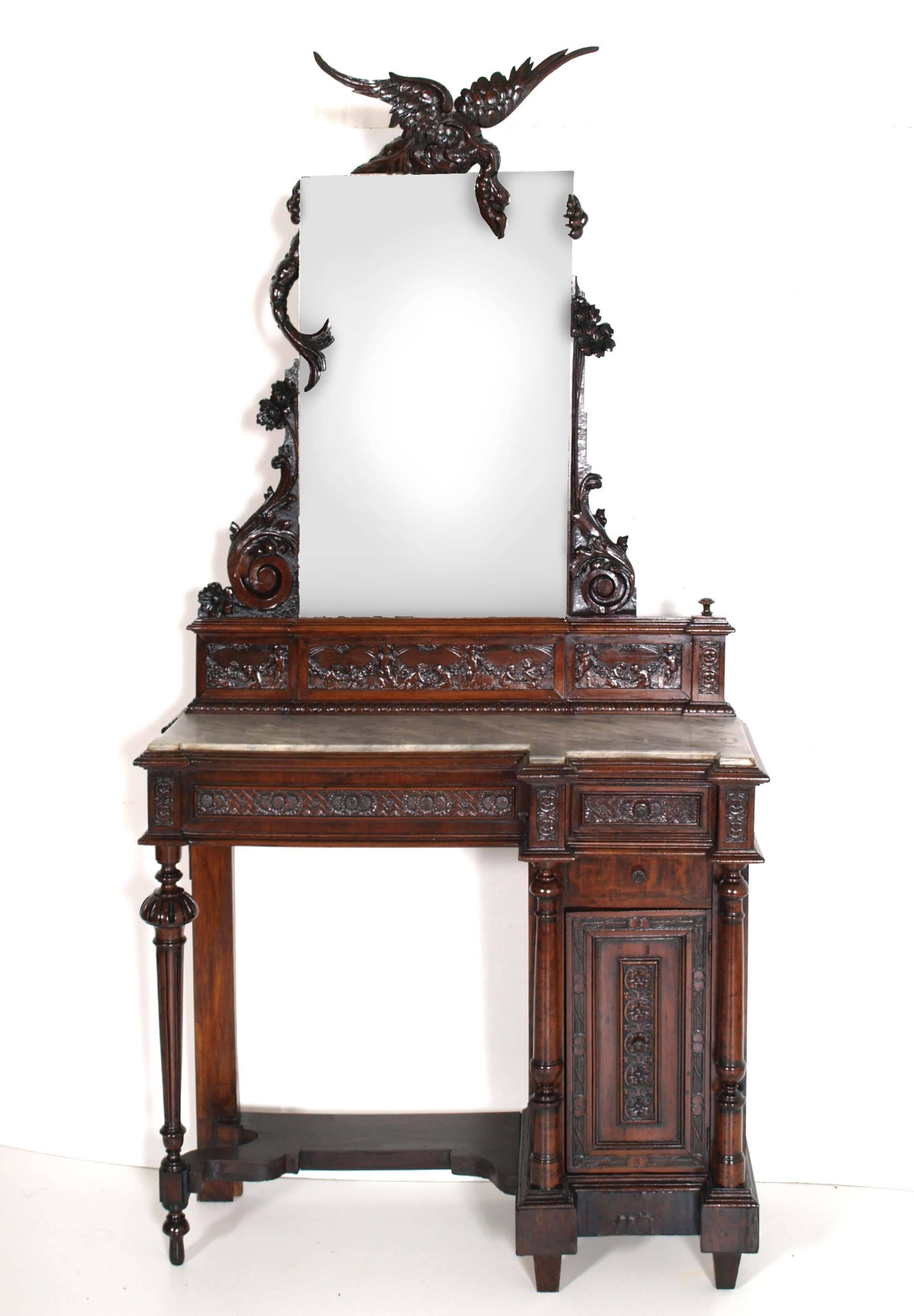 Very importsant console vanity in solid walnut, finely hand-carved, with top shaped grey marble. Very special processing that surrounds the rectangular mirror by Salviati Murano, depicting a griffin or dragon. Floral carvings all performed by hand,