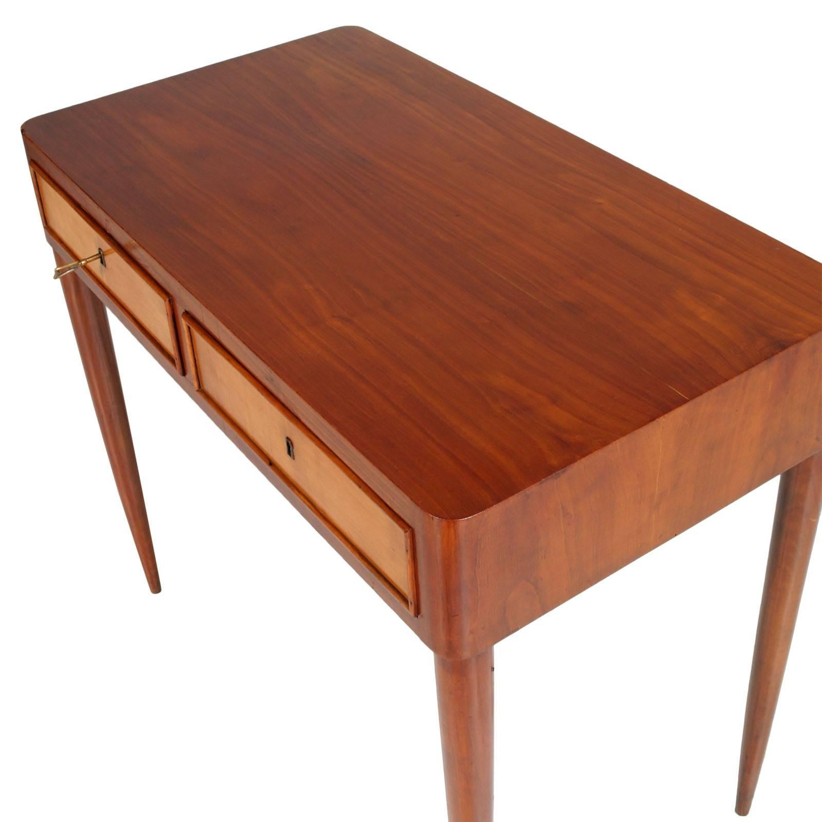 This stunning Mid-Century desk or vanity or console in massive walnut and walnut applied on the top features a vintage maple finish on the two drawers. Sleek design with long tapered legs. This beautiful piece offers plenty of room for storage while