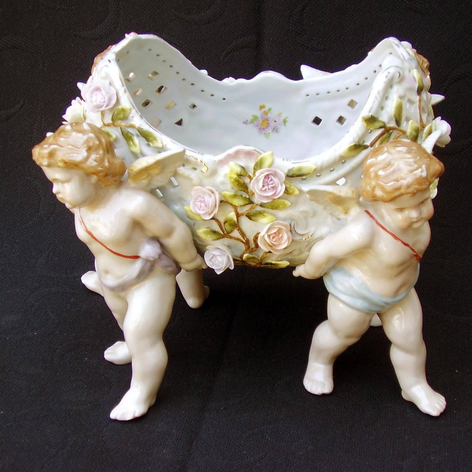 This item is a big 19th century Viennese porcelain centerpiece bowl or jardinière beautifully enameled in rich colors with floral sprays and gilt highlights. This stunning Rococo piece heavily attributable to Meissen also features rose flower in