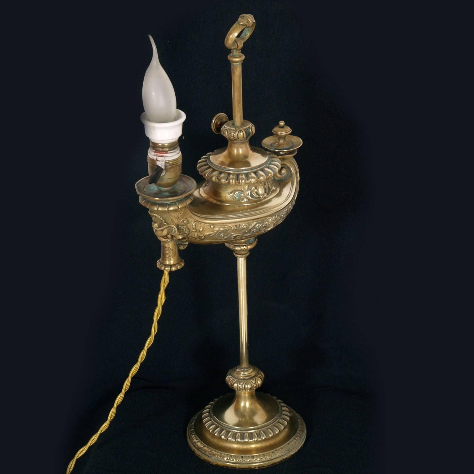 Table golden bronze lamp by Harvard Student, patent Wild & Wessel, aladino brass golden. 

Harvard German student lamp, Patent Wild & Wessel, Berlin. The lamp was subsequently electrified and the burner was removed leaving the white ceramic