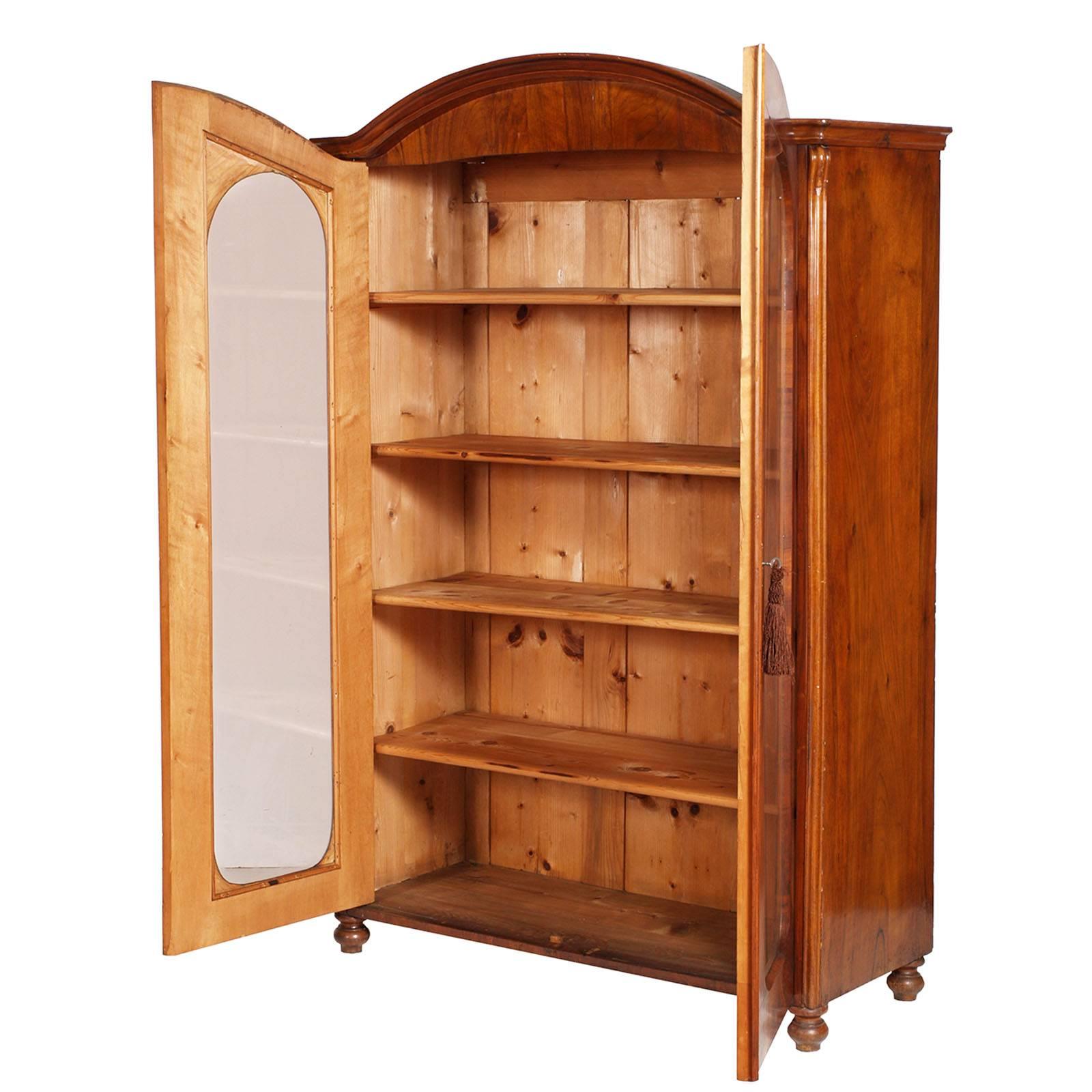 19th century Biedermeier bookcase  from Vienna in walnut applied as herringbone. Restored and finished to shellac and wax. 
The price includes the assembly of the transparent or printed glass chosen by the purchaser

Measures cm: H 187, W 124, D