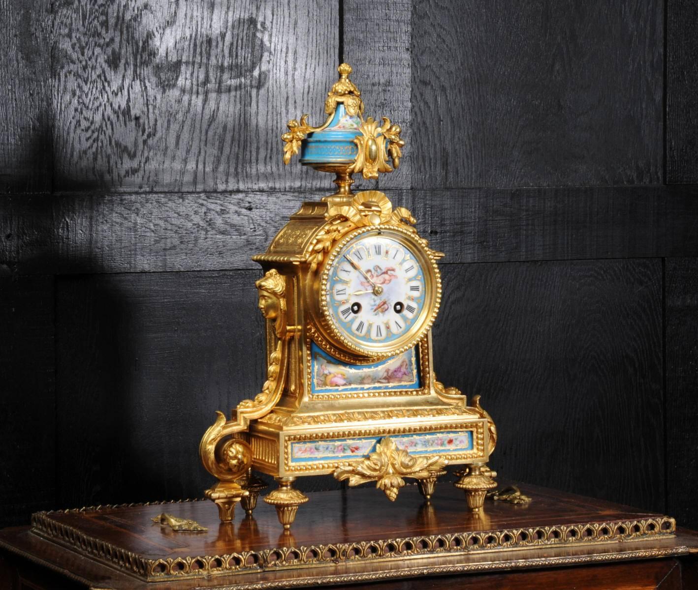 A stunning boudoir clock, fine original gilt bronze-mounted with lovely Sevres style porcelain, exquisitely decorated with a Bleu Celeste ground. it is a celebration of love, the dial features cupid about to launch an arrow above his quiver and