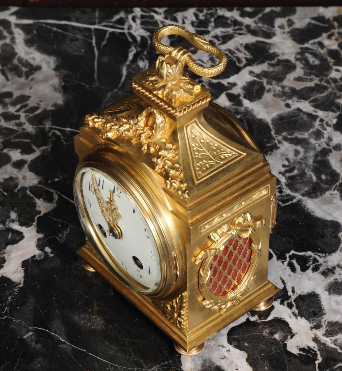 A lovely and rare antique French Pendule d'Officier, ideal as a desk clock. This tiny (by French clock standards) case has a Pendule d'Paris movement with beautifully sonorous gong striking squeezed inside. It is exquisitely made in gilt bronze,