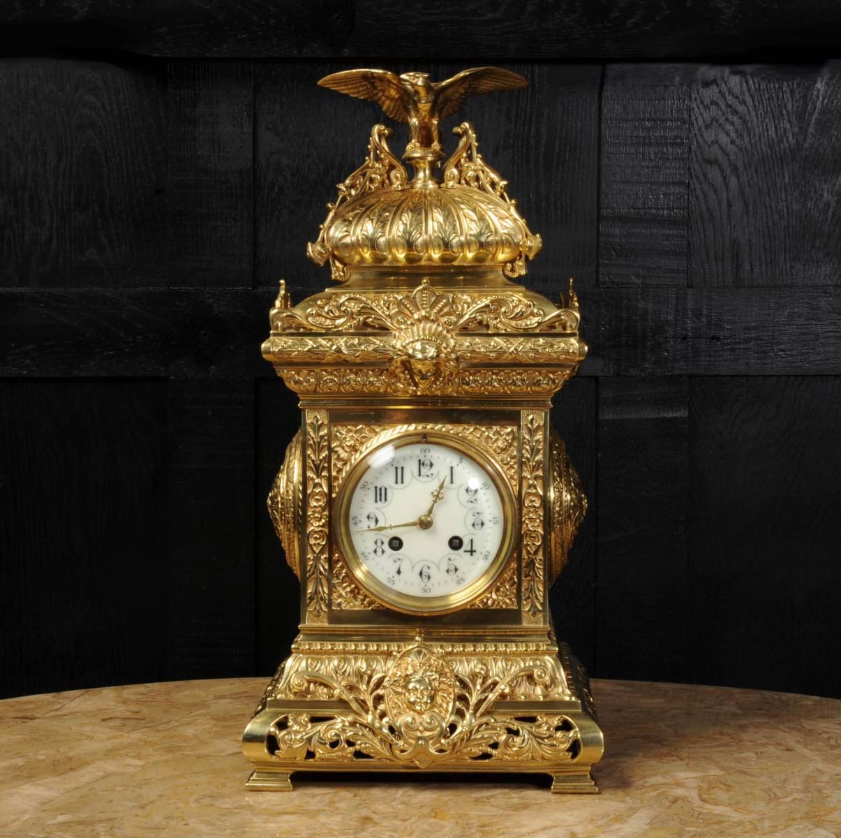 A stunning large sized original antique French table clock. It is in the classical style and features a beautifully modelled eagle seated on the cushion shaped top. The case is decorated with acanthus leaves and acanthus roundels to the sides with
