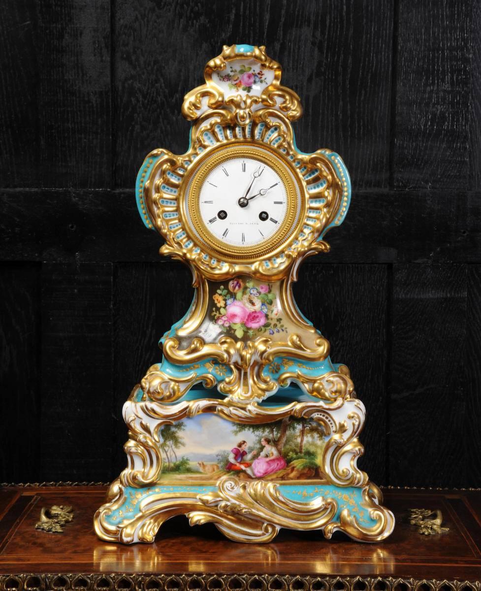 A beautiful, early original antique French porcelain clock. It is of Rococo design, decorated in the style of Sèvres with Bleu Céleste ground and the most charming painted decoration of flowers and a couple in a country setting. It is in the most