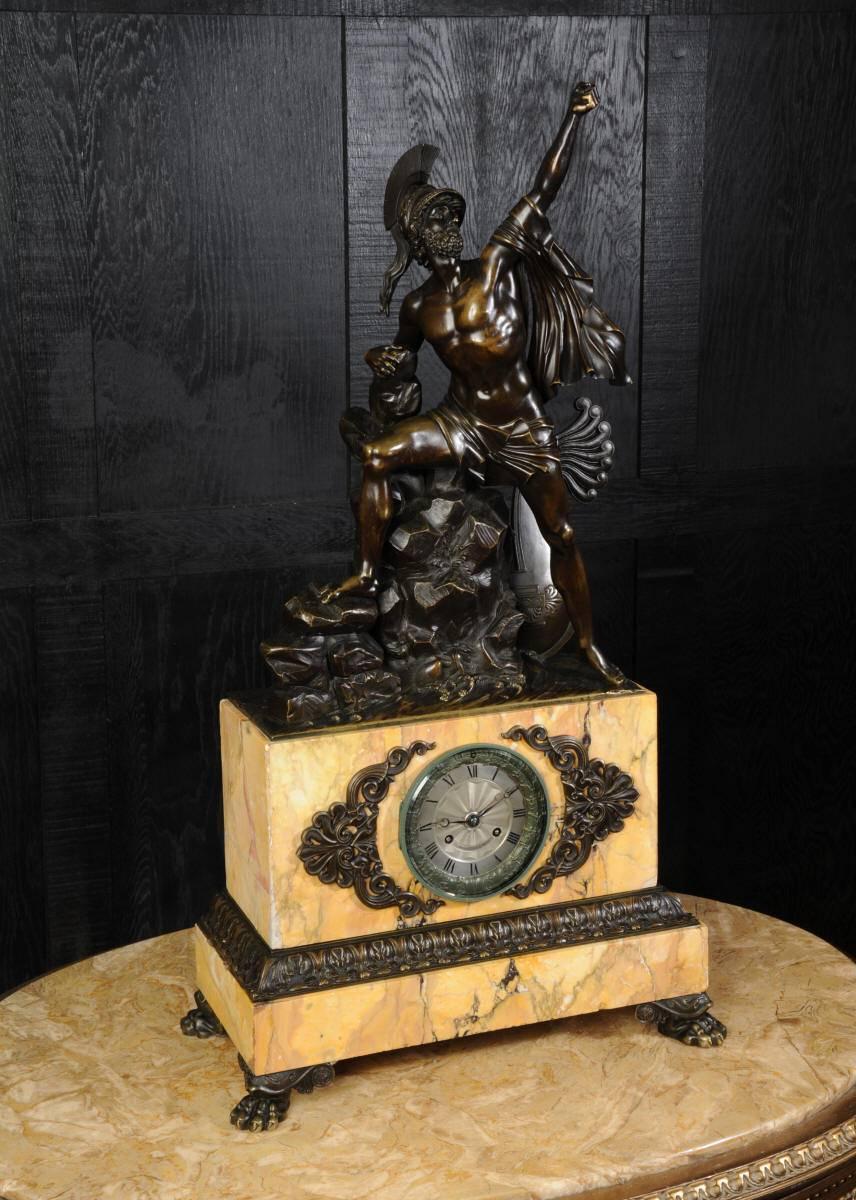 A monumental early bronze and Sienna marble clock by the superb maker Honoré Pons. The stunning sculpture depicts Agamemnon who led the Greeks to victory at Troy as told in Homer's Iliad. He stands on the rocks, sea washing around him with fist