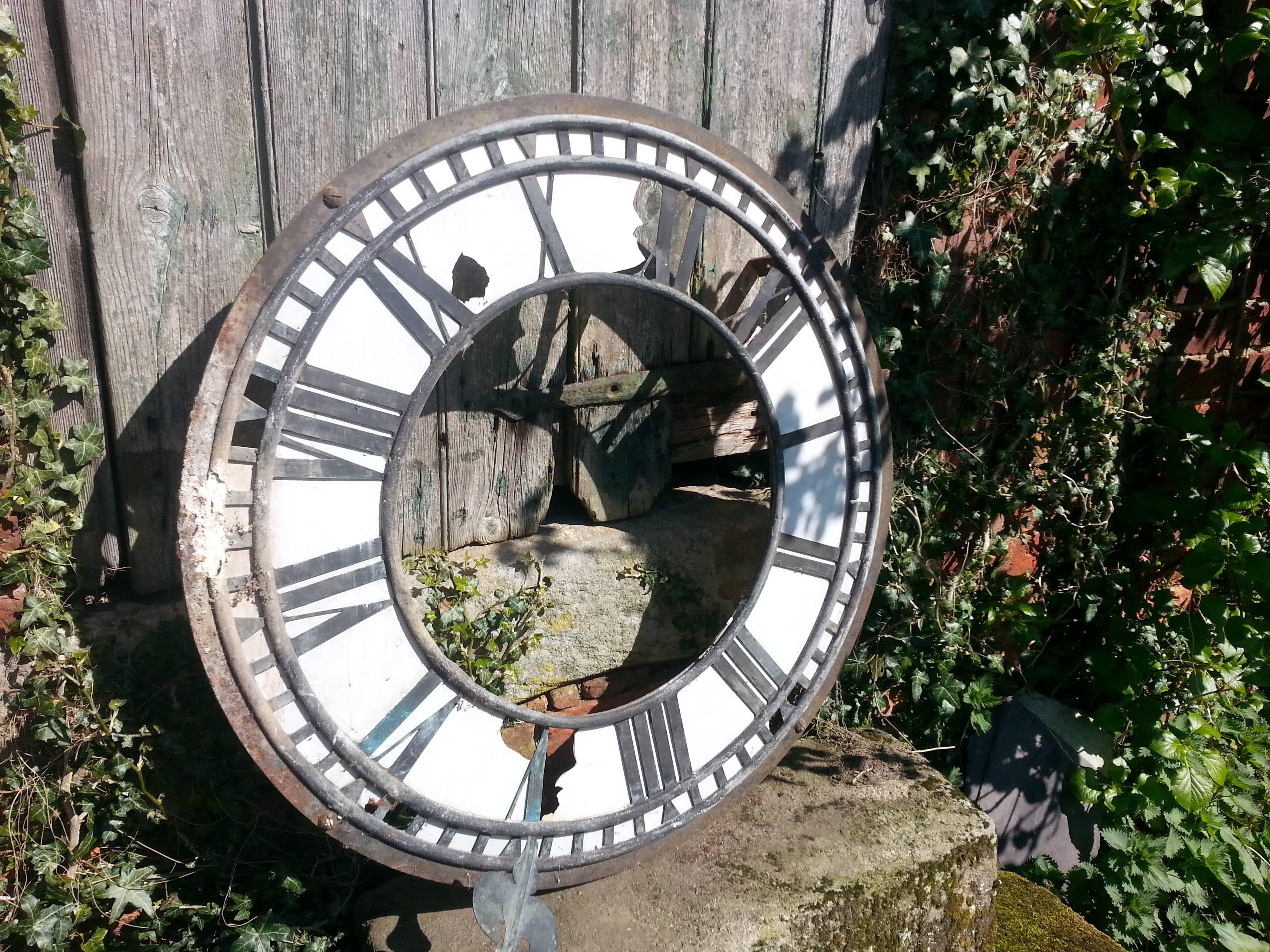 A lovely and rare large Victorian copper and iron clock dial reclaimed from a lace mill, complete with original copper hands with bracket and part motion work. It is in a lovely patinated as found condition with great color. Some damage to the white
