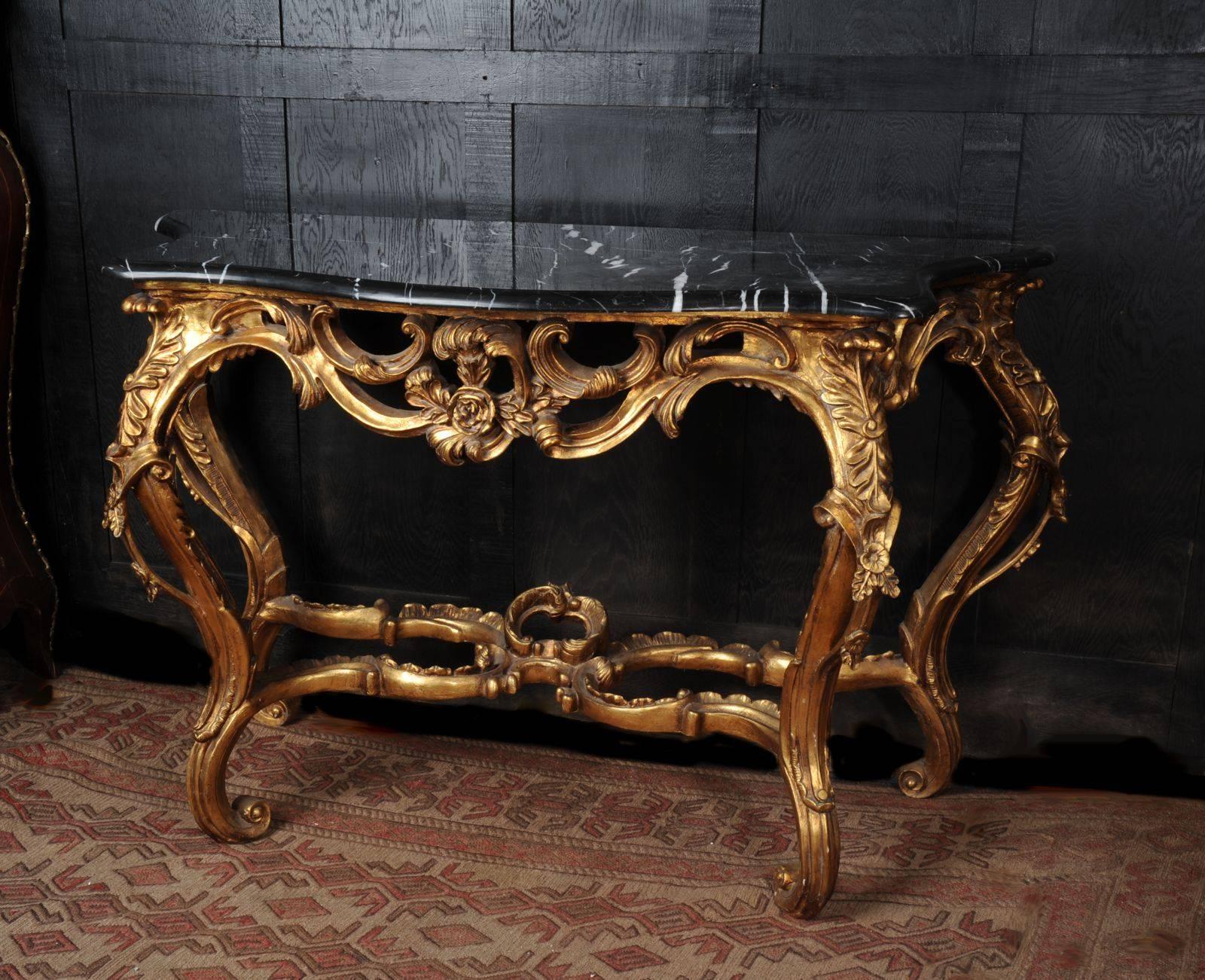 A lovely large serpentine Rococo console table with black marble top. Vintage of some age with a great look. Marble has some fading to one side but a good polish.