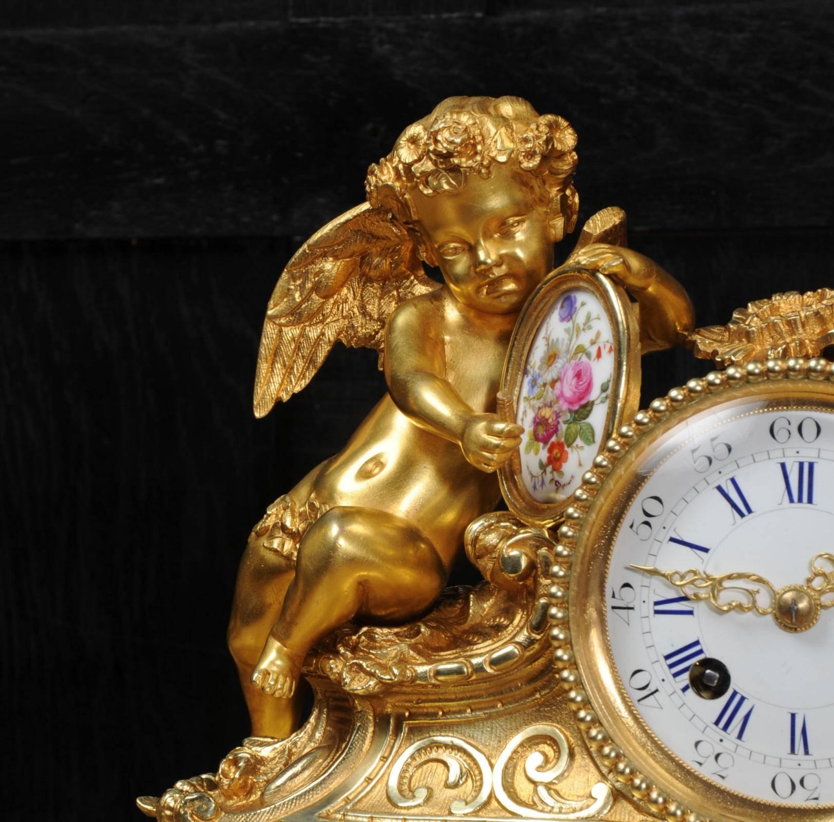 A fine and early clock set by the famous maker Japy Freres, in full working order. It is of superb quality in fine gilded bronze-mounted with delicately painted Sèrves style porcelain. It features a putto painting a panel of finely painted flowers.