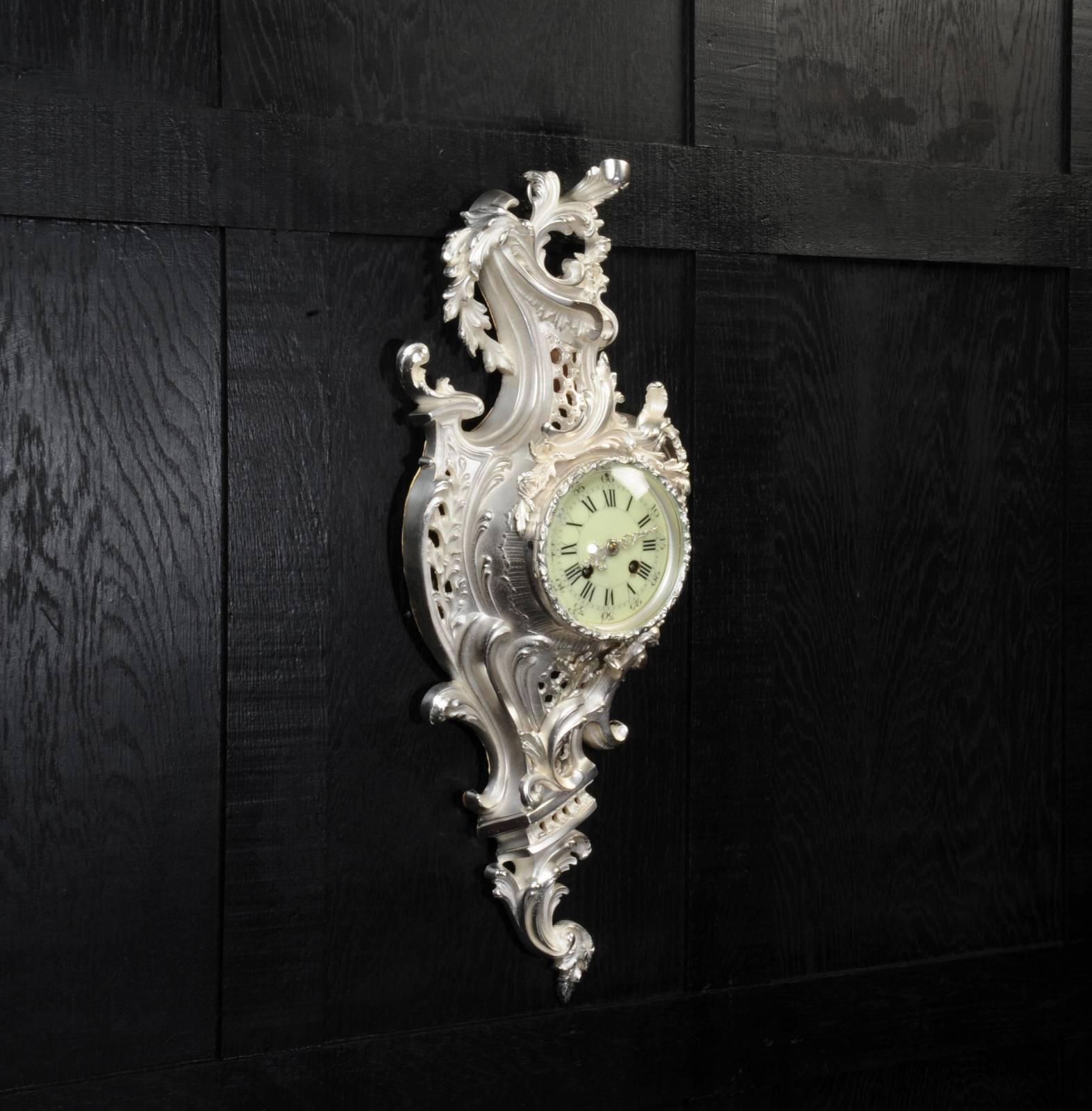 A rare and very decorative silver plated Antique French Rococo wall clock. Stunning asymmetric design with scrolling foliage and floral swags. It is finely modelled in silver plated bronze, polished and matted, a beautiful and unusual variation on