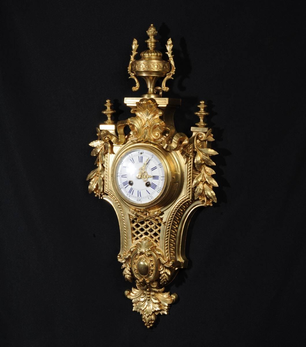 A stunning original antique French cartel wall clock by the famous maker Japy Freres. It is Louis XVI in style, classical case with acanthus swags, a large acanthus motive above the dial and a large urn to the top. The front is fretted to allow the