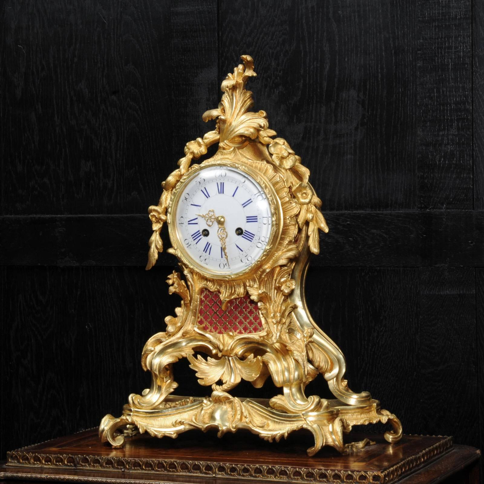 A very fine and substantial ormolu table clock by Vincenti. It is of the the highest quality, beautifully modelled and finished in glorious ormolu (finely gilded doré bronze). The case is of classic Rococo design, bold, waisted keyhole shape with