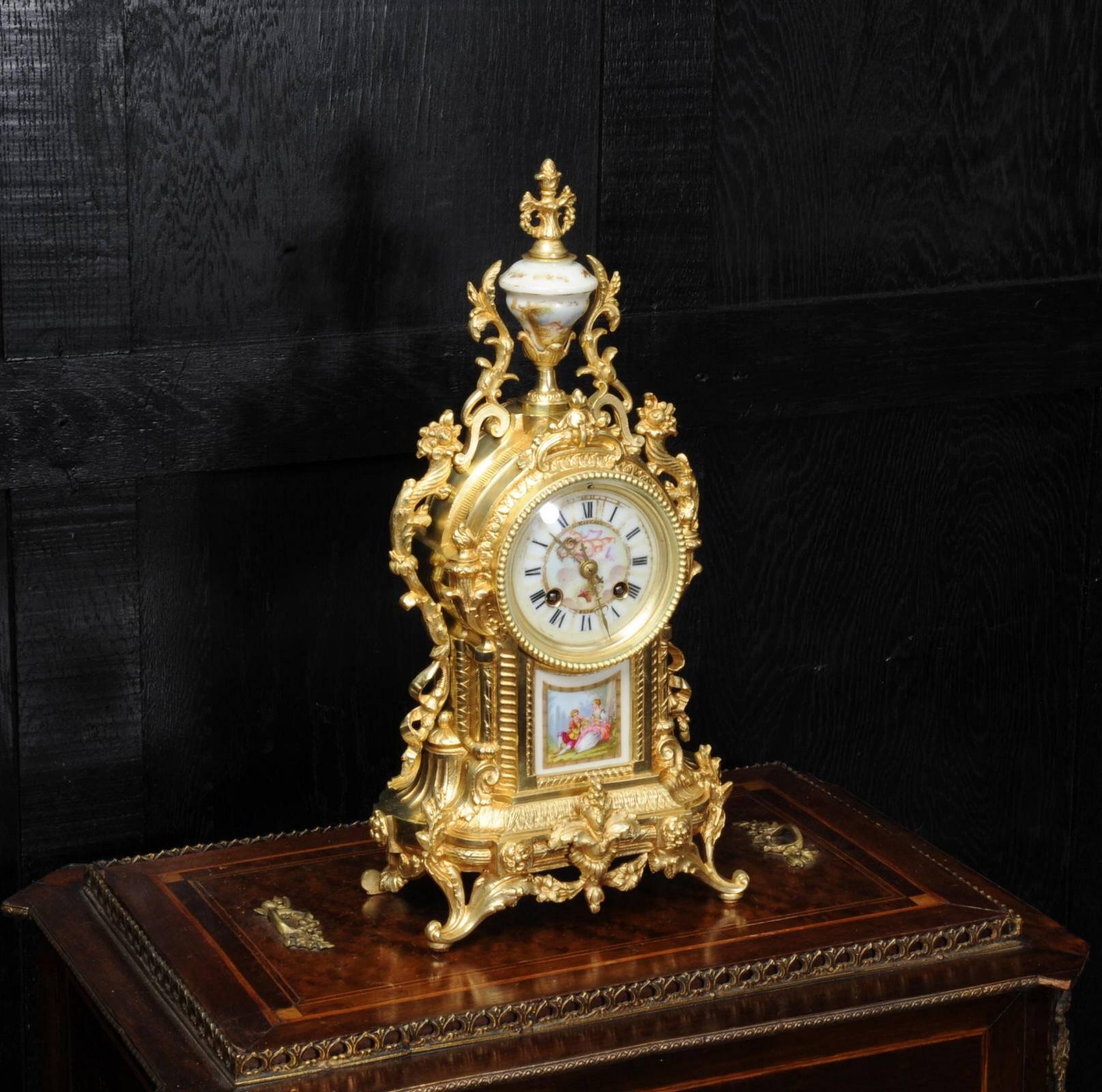 A beautiful antique French ormolu (gilt bronze) clock with exquisitely decorated Sèvres style porcelain panel, urn and dial. The movement is by the distinguished clockmaker Achille Brocot. The style is Louis XVI, decorated with acanthus, scrolling