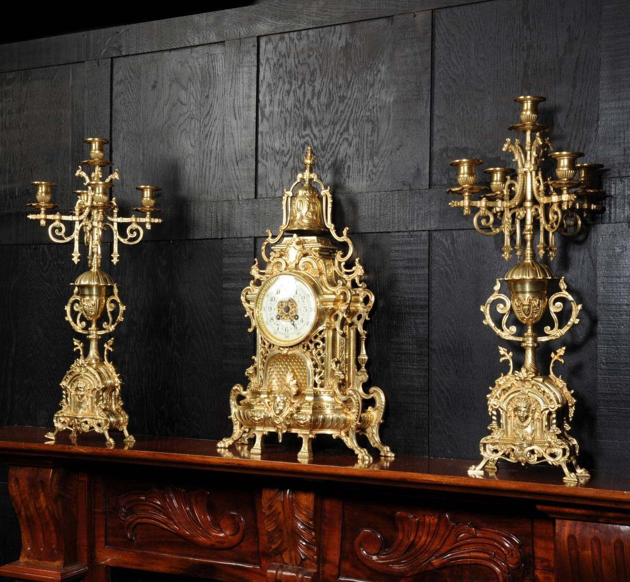 A large and impressive original antique French Gothic clock set, beautifully made in gilt brass, very heavy and crisply modelled and with the original gilding remaining. The style is typically French Gothic, architecturally designed with lions