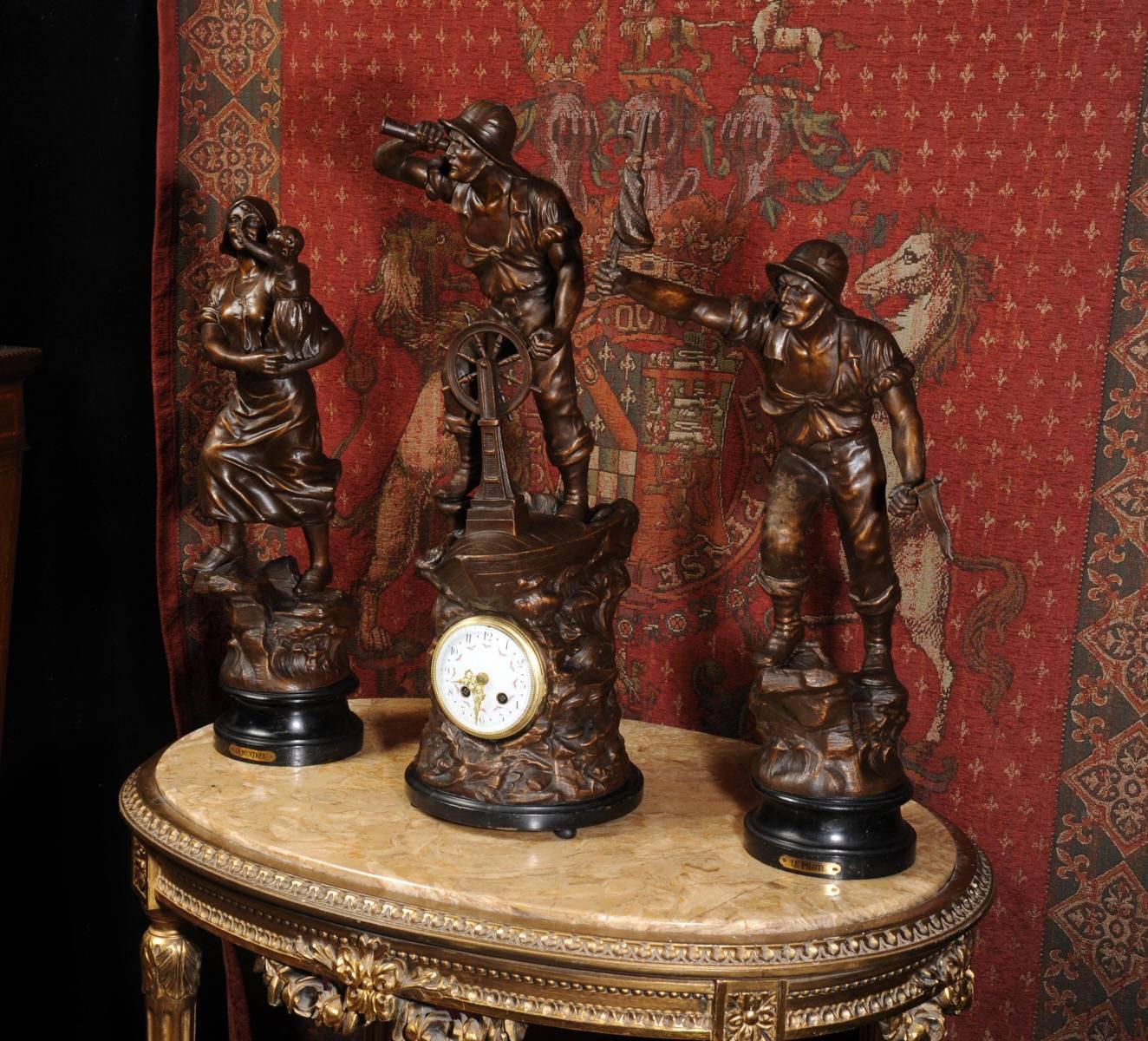 A large and stunning clockset of beautiful modelled bronzed patinated metal figures mounted on ebonised wooden bases, not marked but after Xavier Raphanel. The clockset is a brilliant depiction of adventure. A sailor at the helm of a small wooden