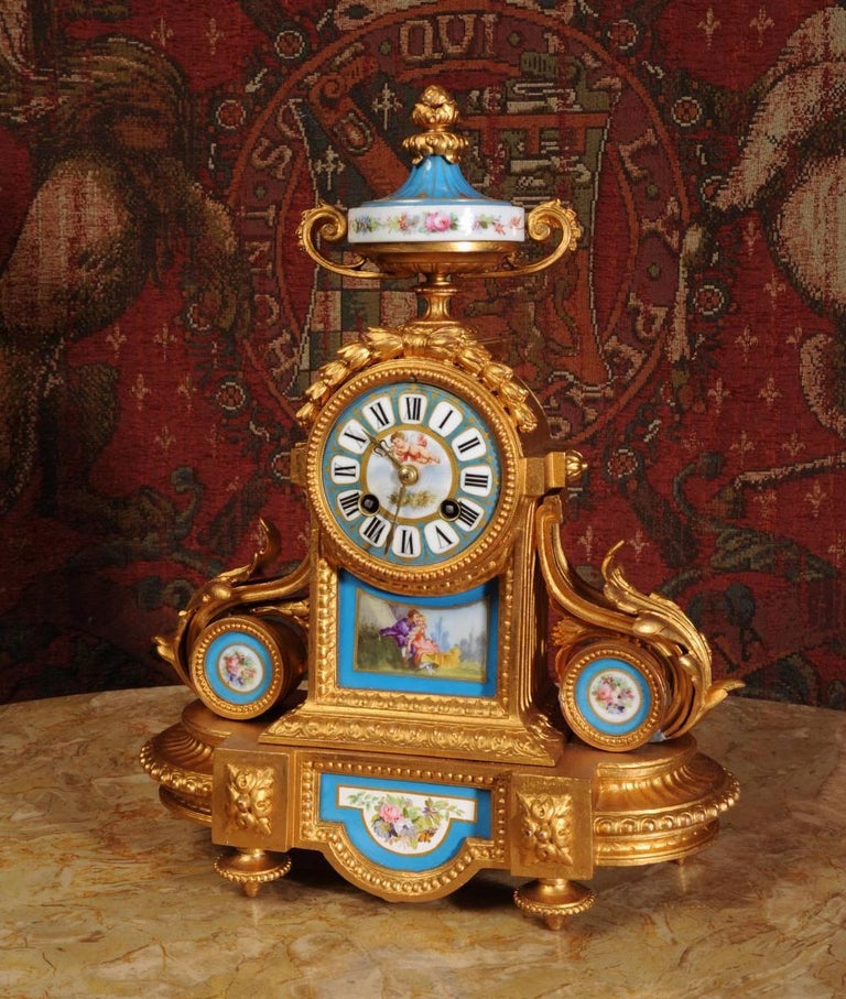 A stunning clock by the famous maker Japy Freres, gilt metal with exquisitely painted porcelain panels in the manner of Sevres. Porcelain has a pompadour blue ground and each piece is delicately decorated with floral swags and over glaze gilt