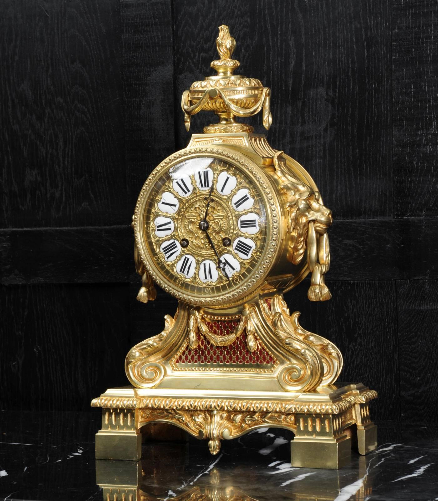 A large, imposing and heavy original antique French gilt bronze clock dating from 1870. It is a beautifully made drum head clock in the classical style of Louis XVI and retailed by G. Philippe, Palais Royal. The movement is mounted in a large drum