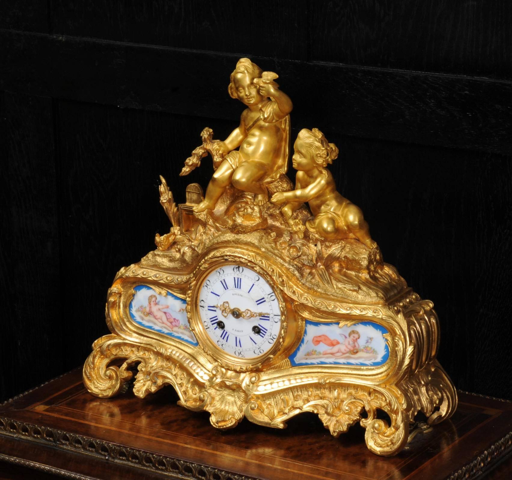 A fine and early original antique French ormolu (fire gilded bronze or bronze doré) clock by Japy Freres and retailed by Rollin of Paris from circa 1850. The clock depicts a charming scene of children playing with their pet birds, beautifully